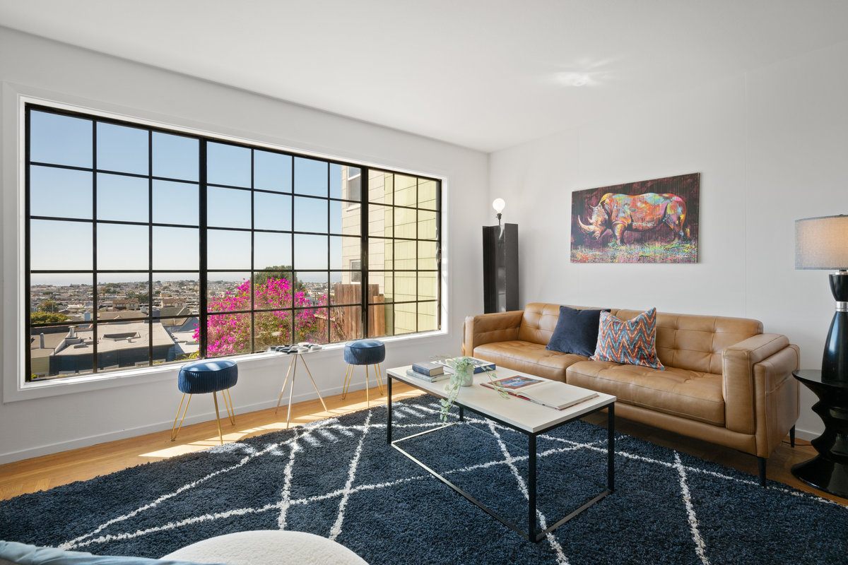 Lower sitting room has large couch and coffe table.