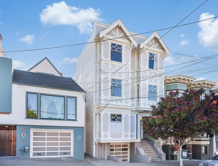 Front exterior view of 1225 Shrader Street, showing a light facade