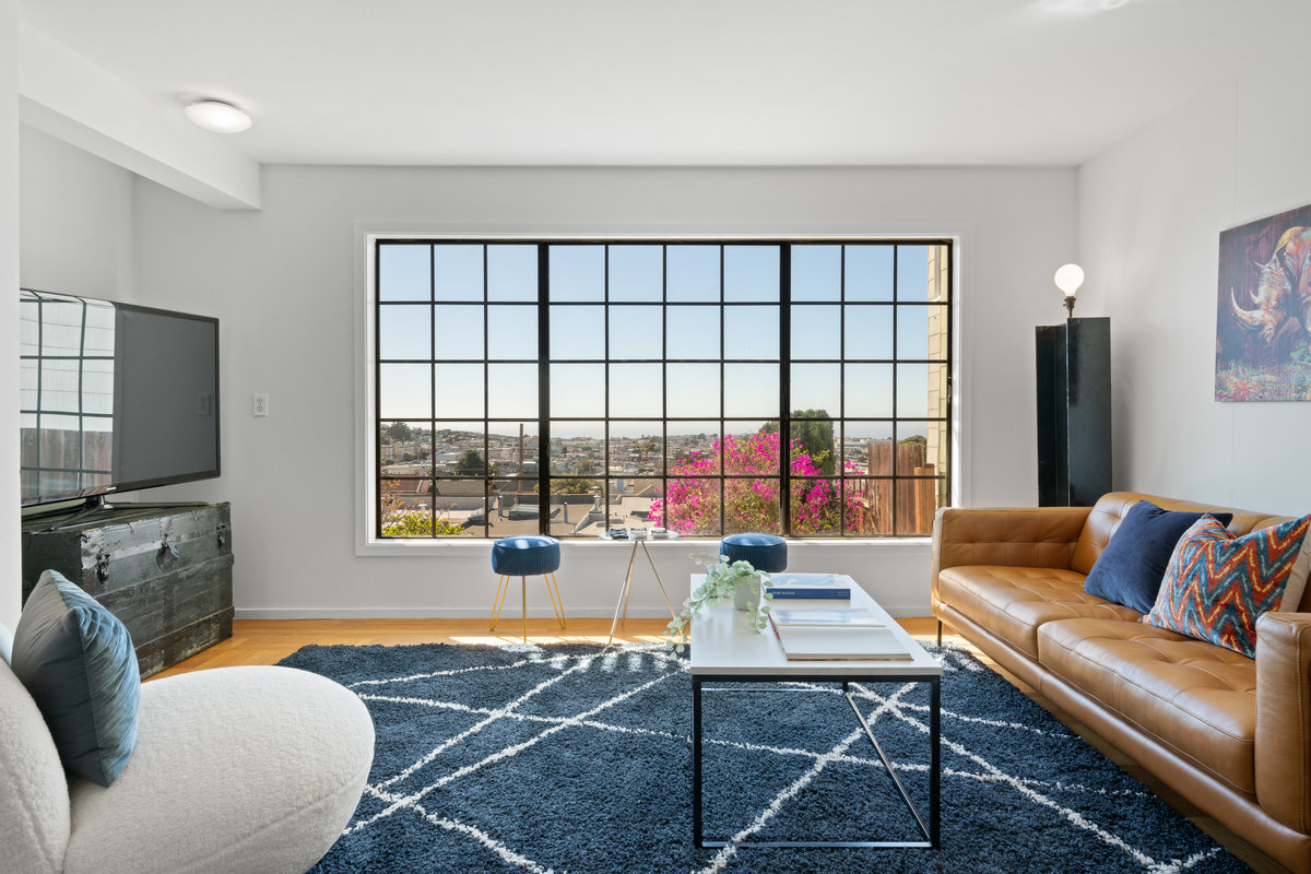 There is a large window in the lower sitting room that looks over large yard and has views to the ocean.