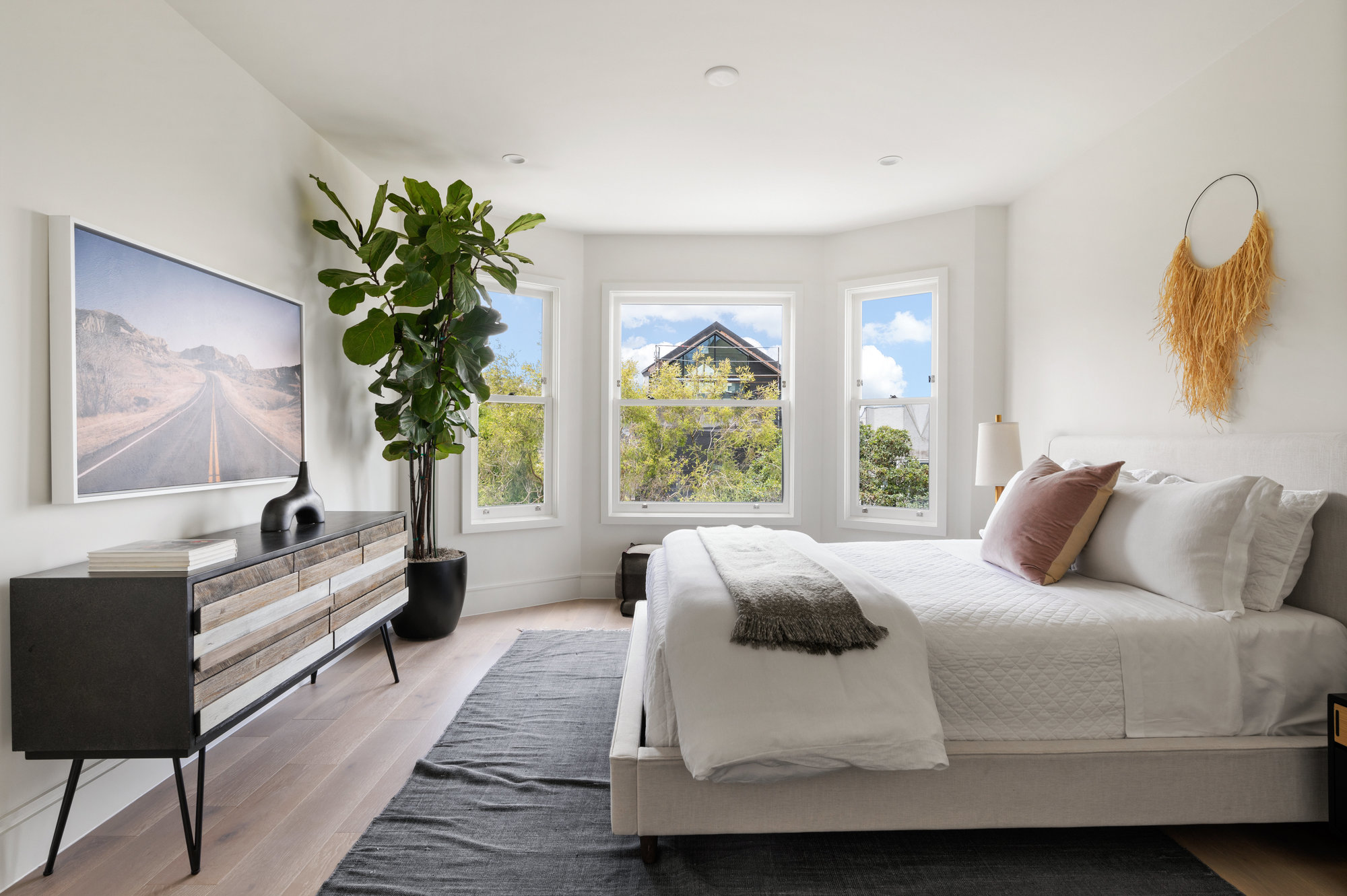 Other guest bedroom that also has large bay windows.