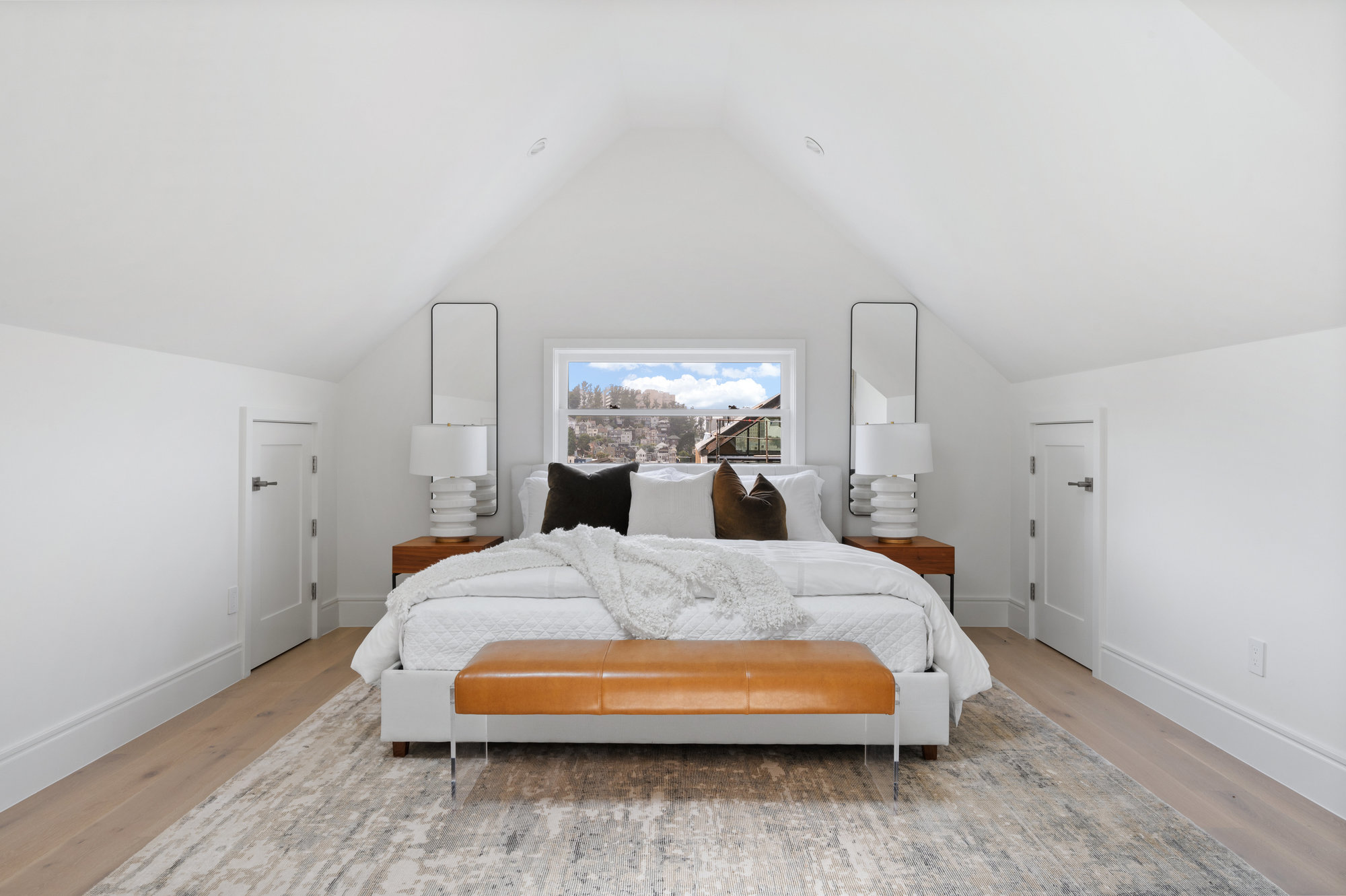 Primary bedroom is on upper level.  There is a window centered above bed.
