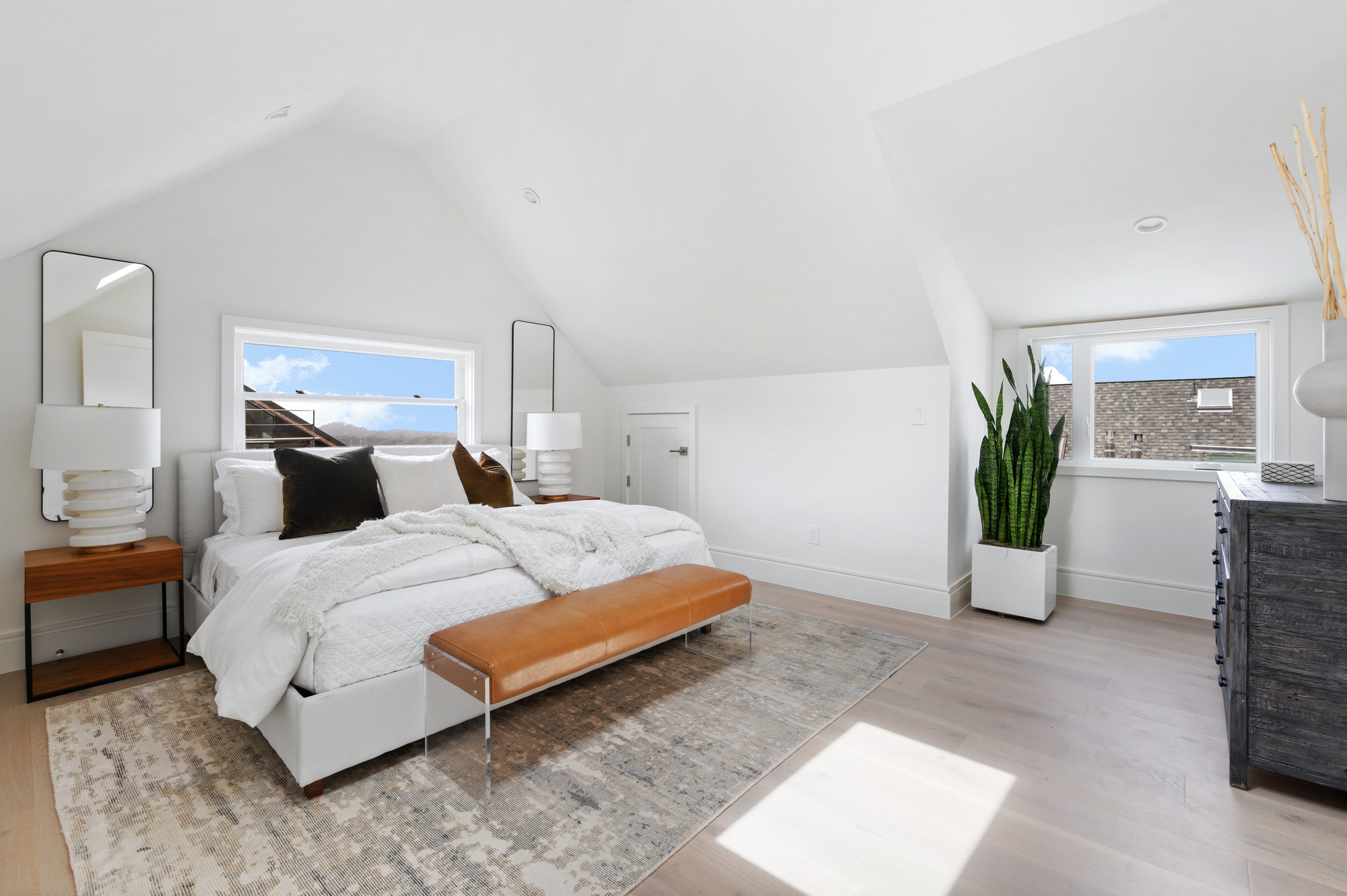 Primary is large room with kin bed, bedside table and large dresser.
