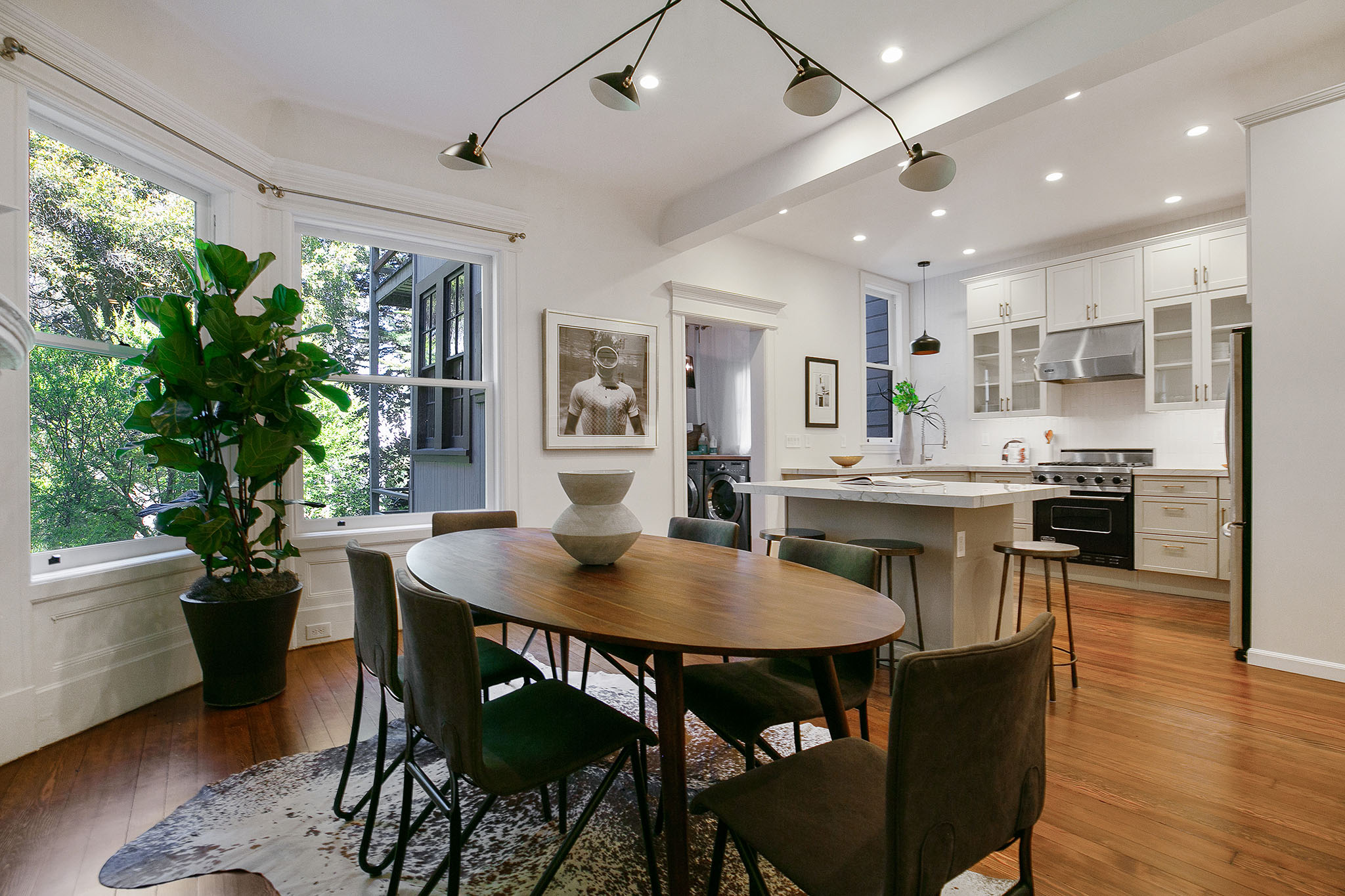 14 View of the dining area, featuring large windows and wood floors