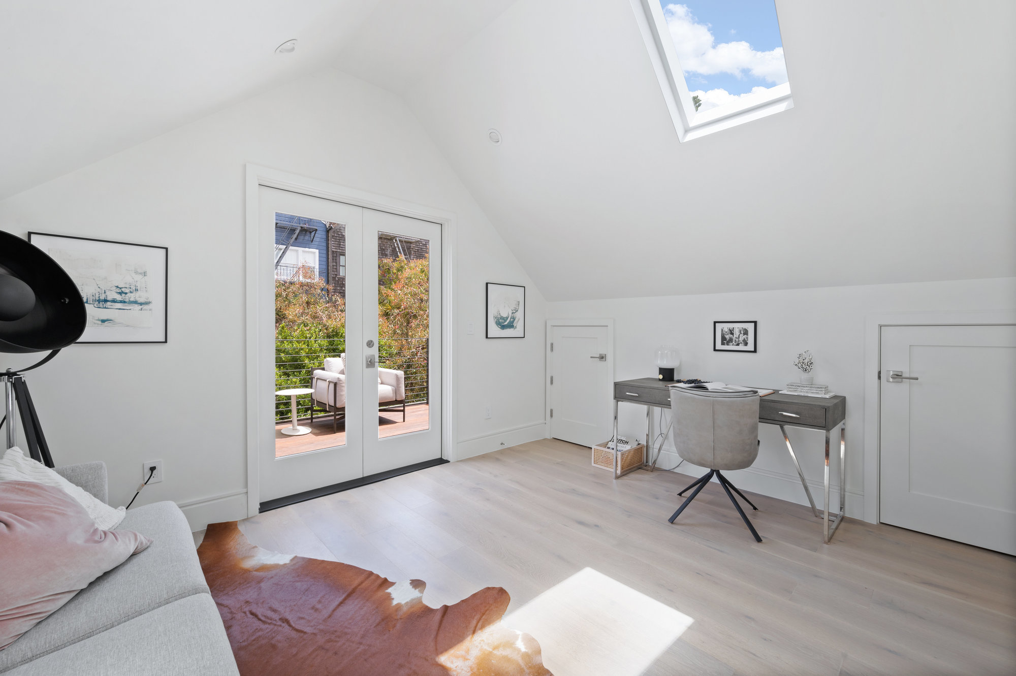 Office space has small couch and desk area.  There skylights that let in lots of light.