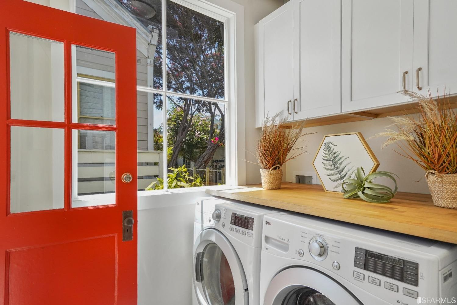 View of the laundry area, featuring storage space