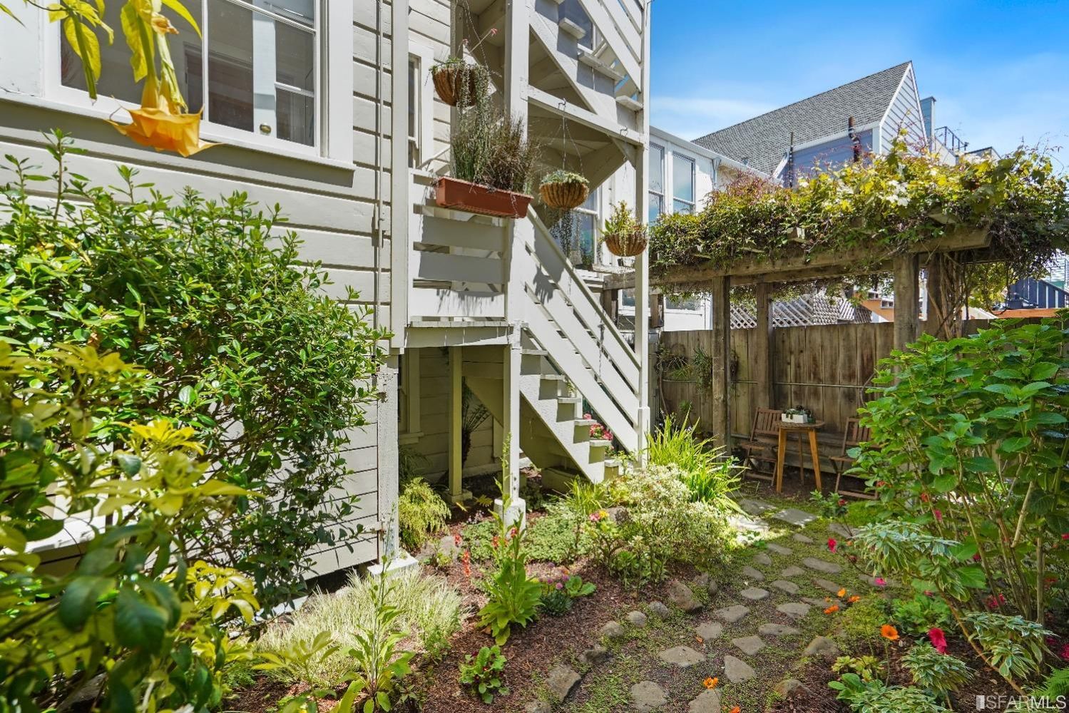 Outdoor space, showing a pergola and stone path