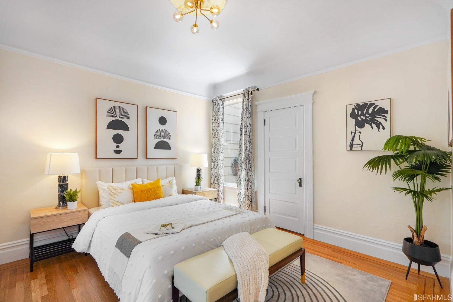 View of the second bedroom, showing wood floors and a large window