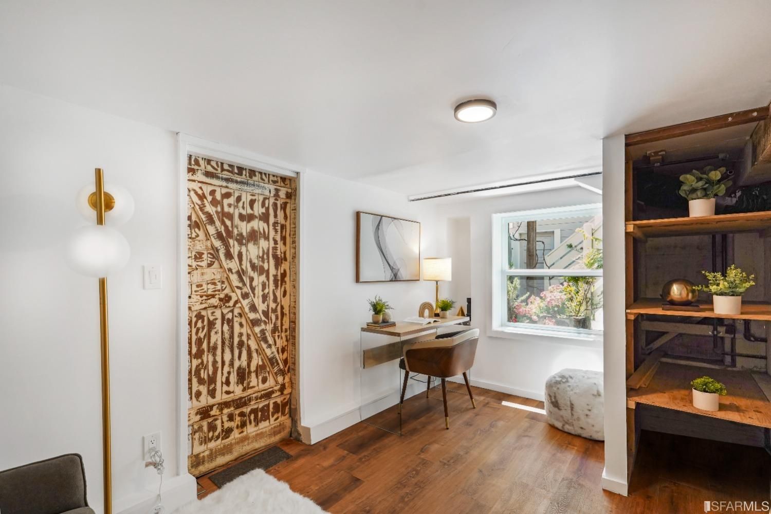 Primary bedroom featuring built-in shelves and a private office area