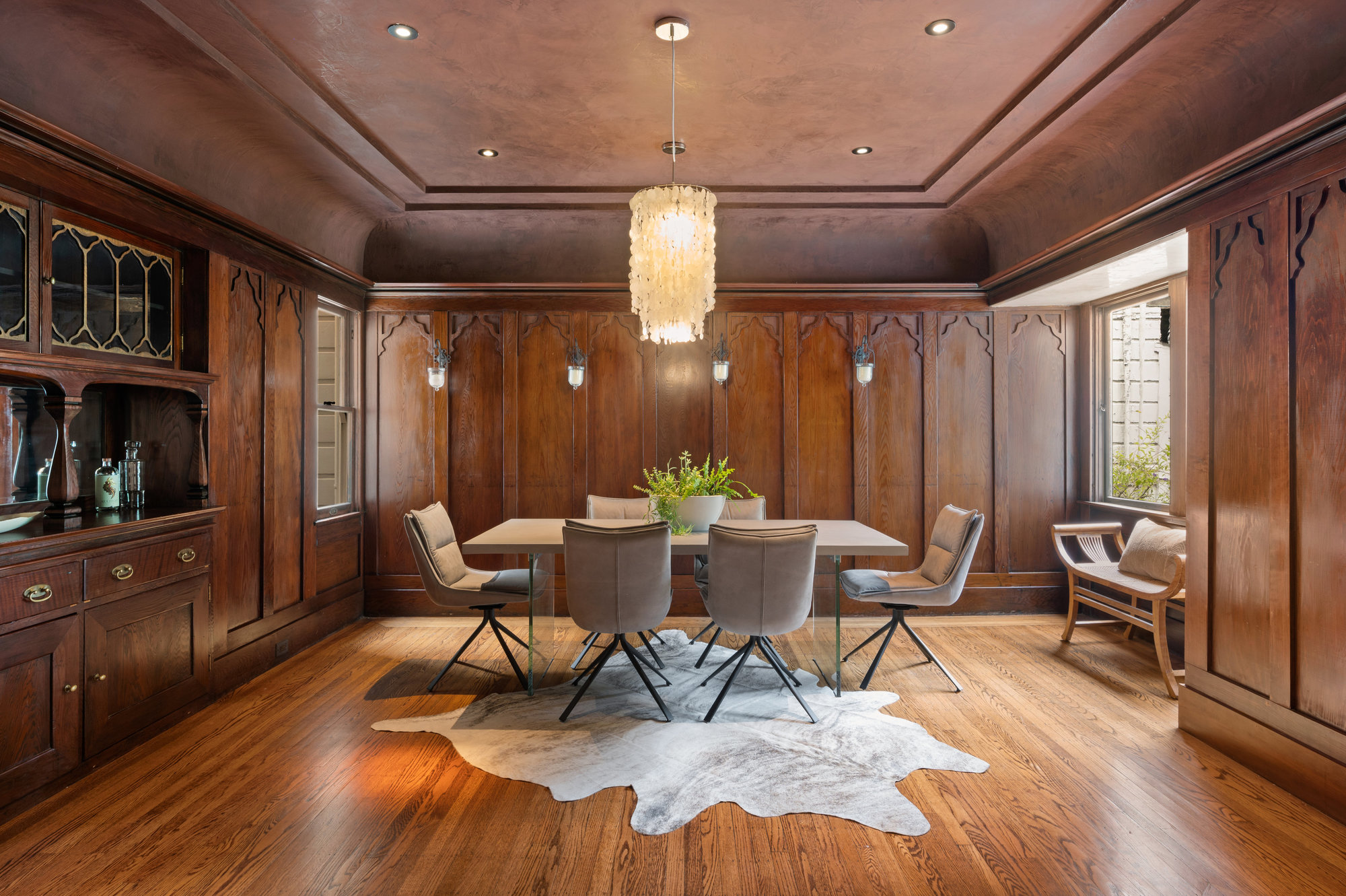 Dining room with wood panels and a fireplace