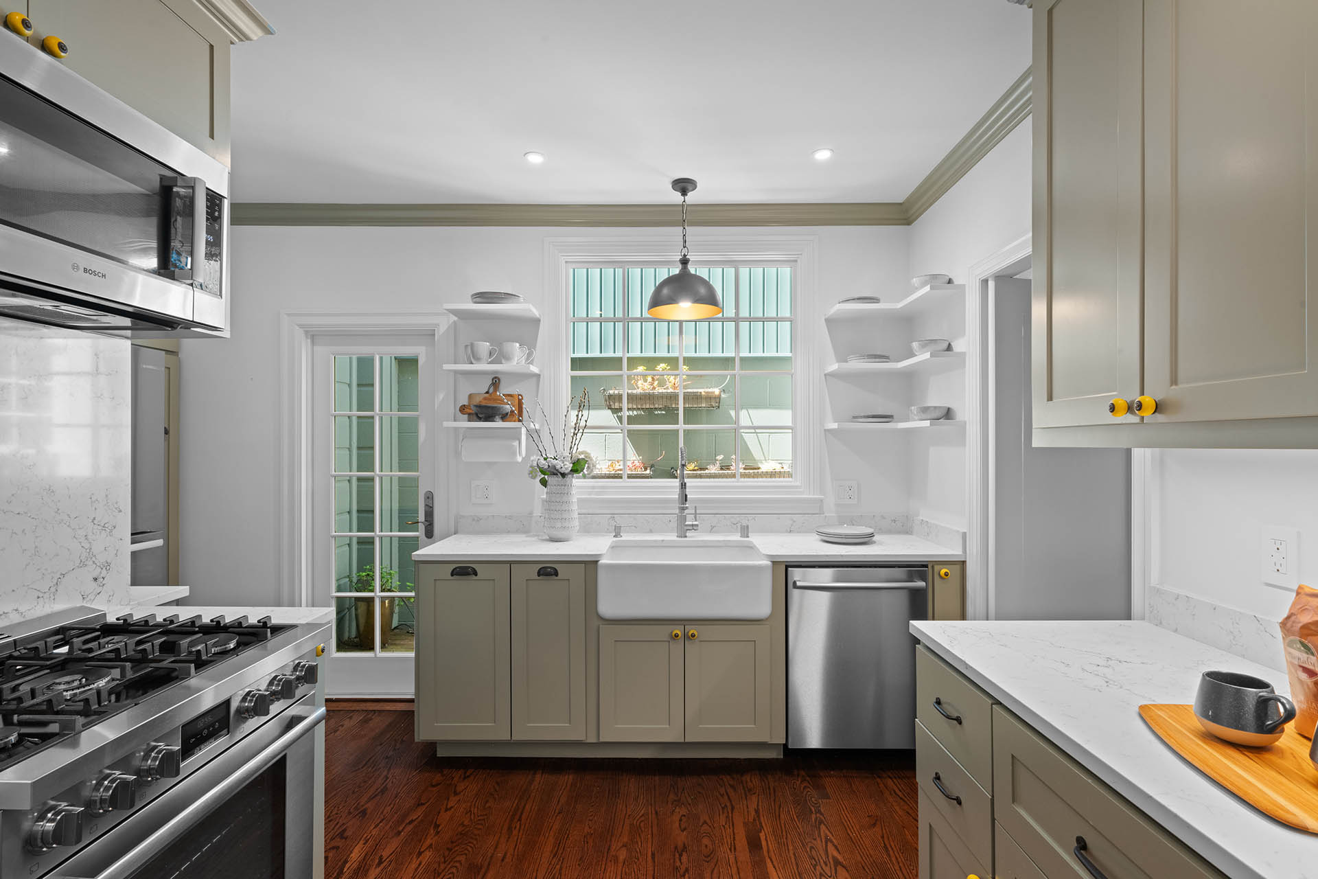 1525willard-kitchen-1 Kitchen has light green cabinets with white stone counter tops.