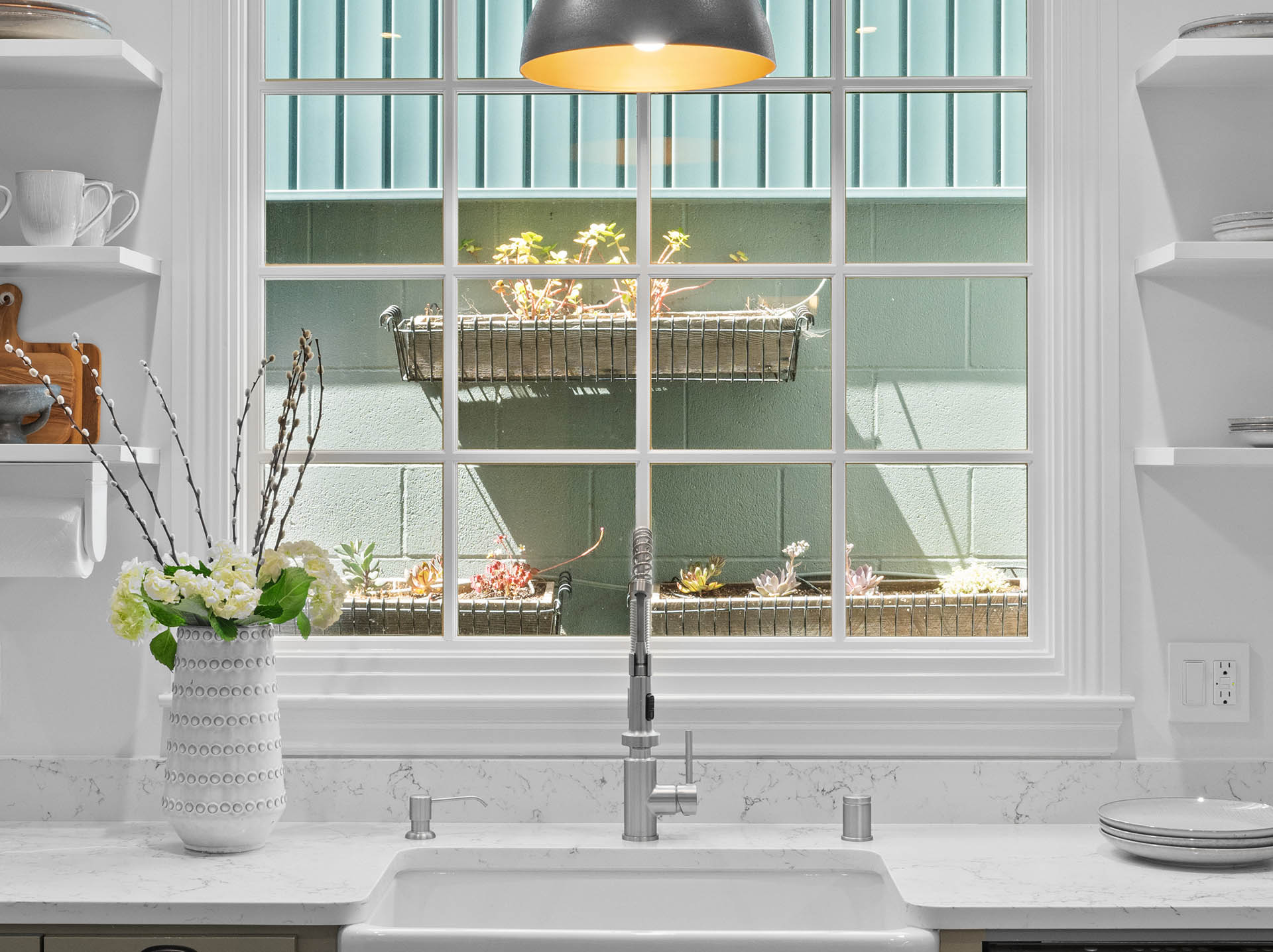 1525willard-kitchen-sink Close up of the sink looking out the window. There are flower boxes with succulents.