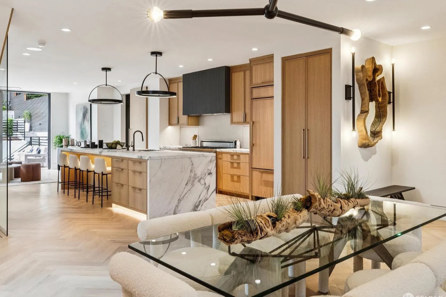 Property Photo: modern living/dining area with light wood flooring and marble counter