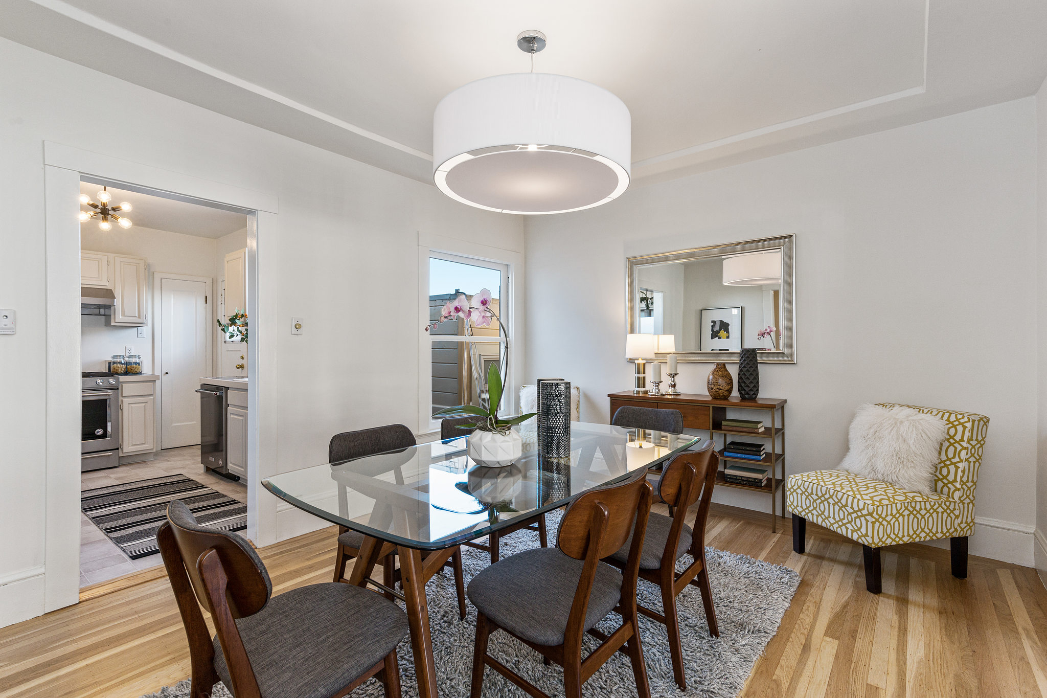 Formal dining room, featuring wood floors and natural light