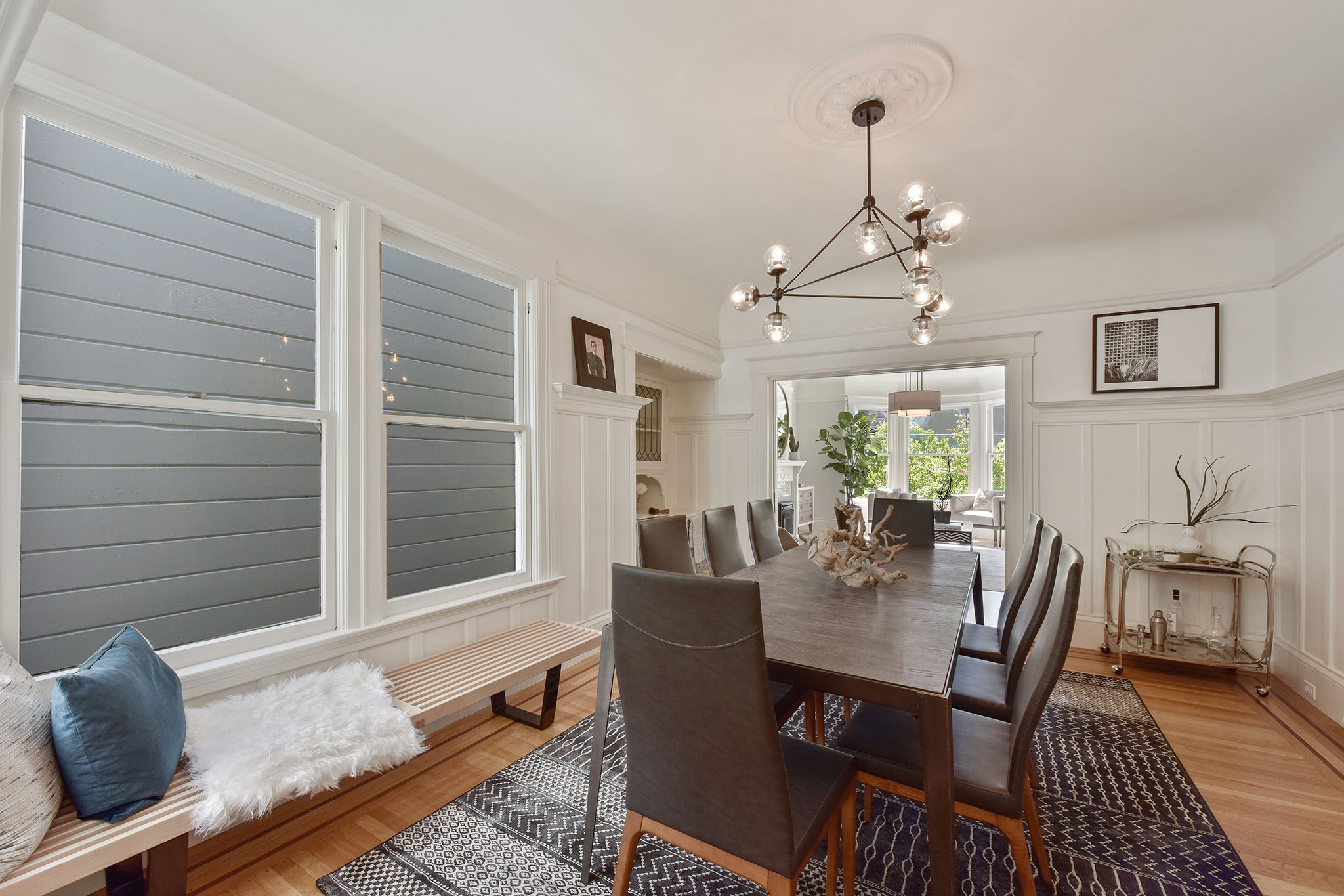Dining room, featuring wood floors and large windows