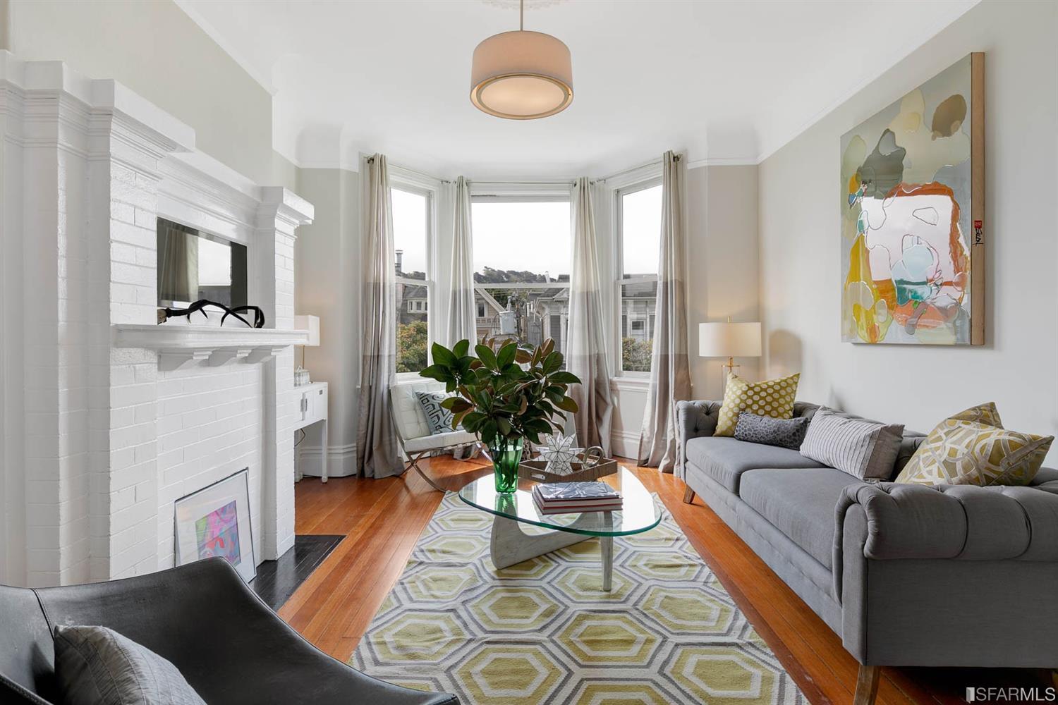 Living room, featuring wood floors and bay windows