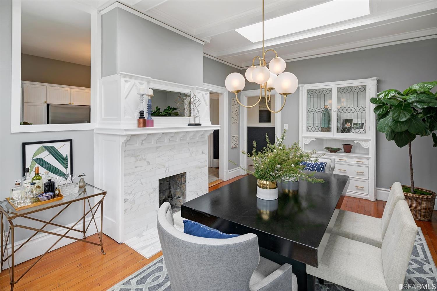 View of the formal dining room, showing a fireplace and a skylight above the table