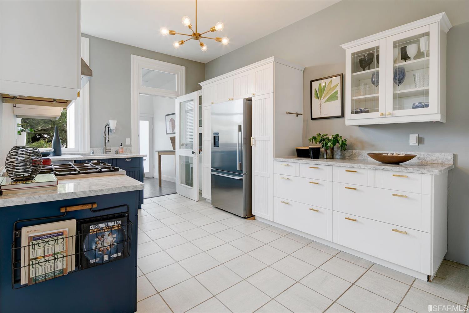 Kitchen, featuring white cabinets and tile floor
