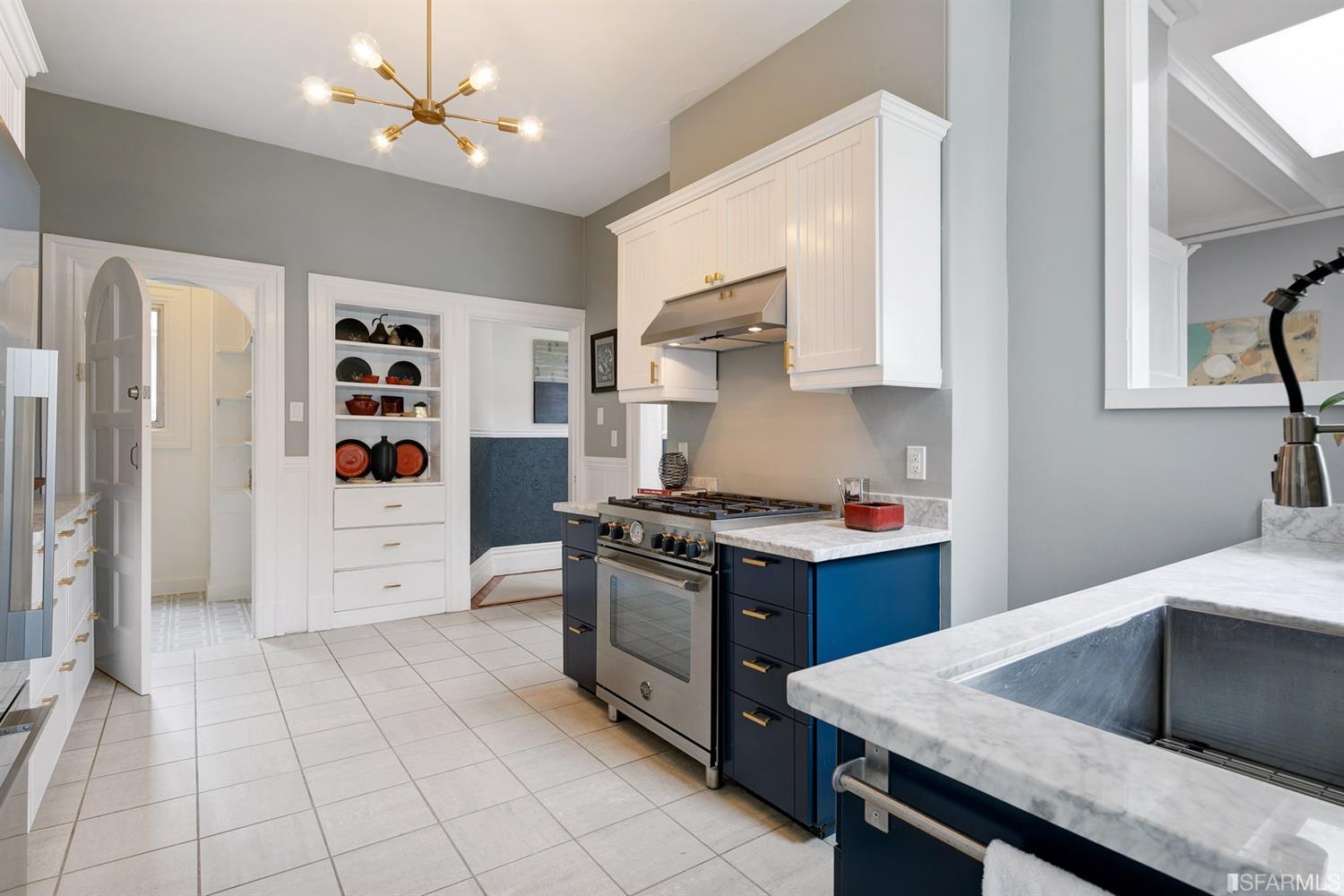 View of the kitchen, showing built-in white cabinets along one wall