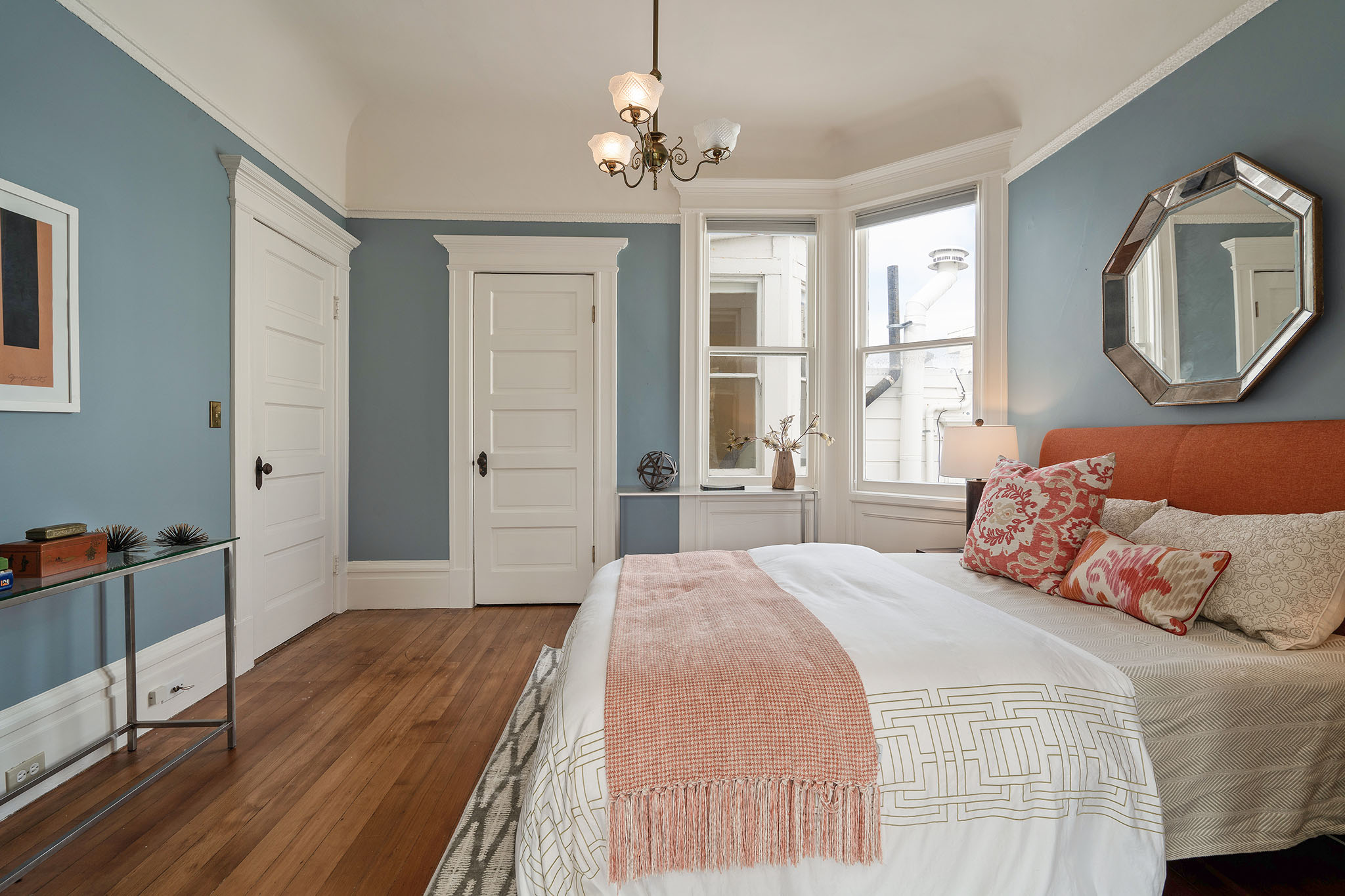 20 Bedroom with wood floors and white wood trim