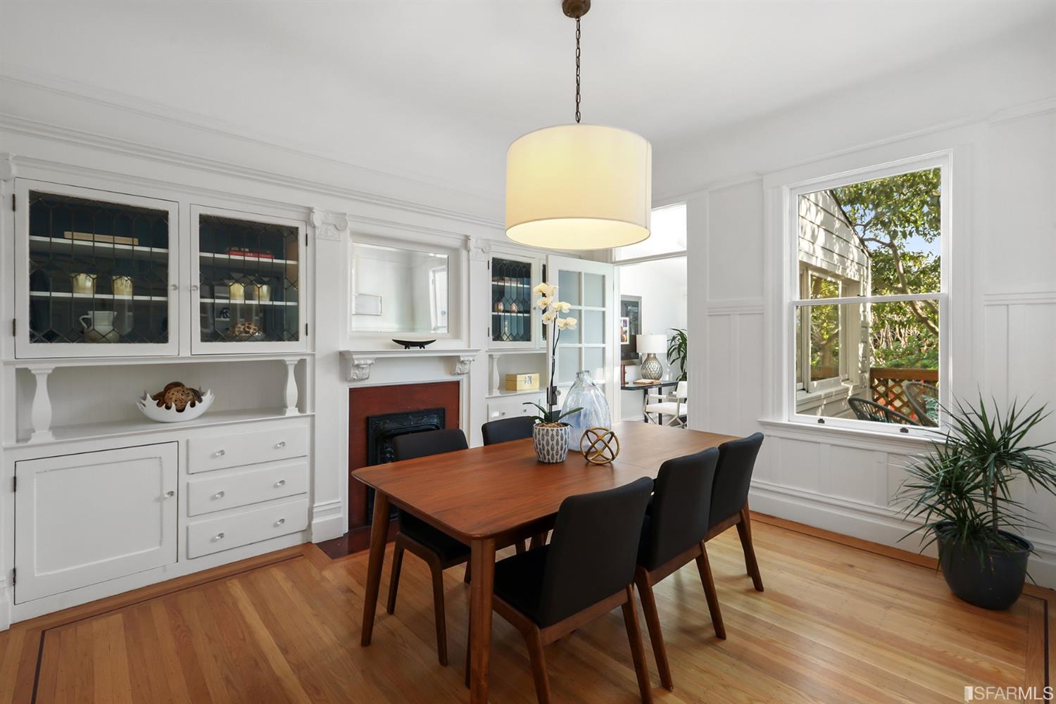 Dining room, showing built-in cabinets and a fireplace