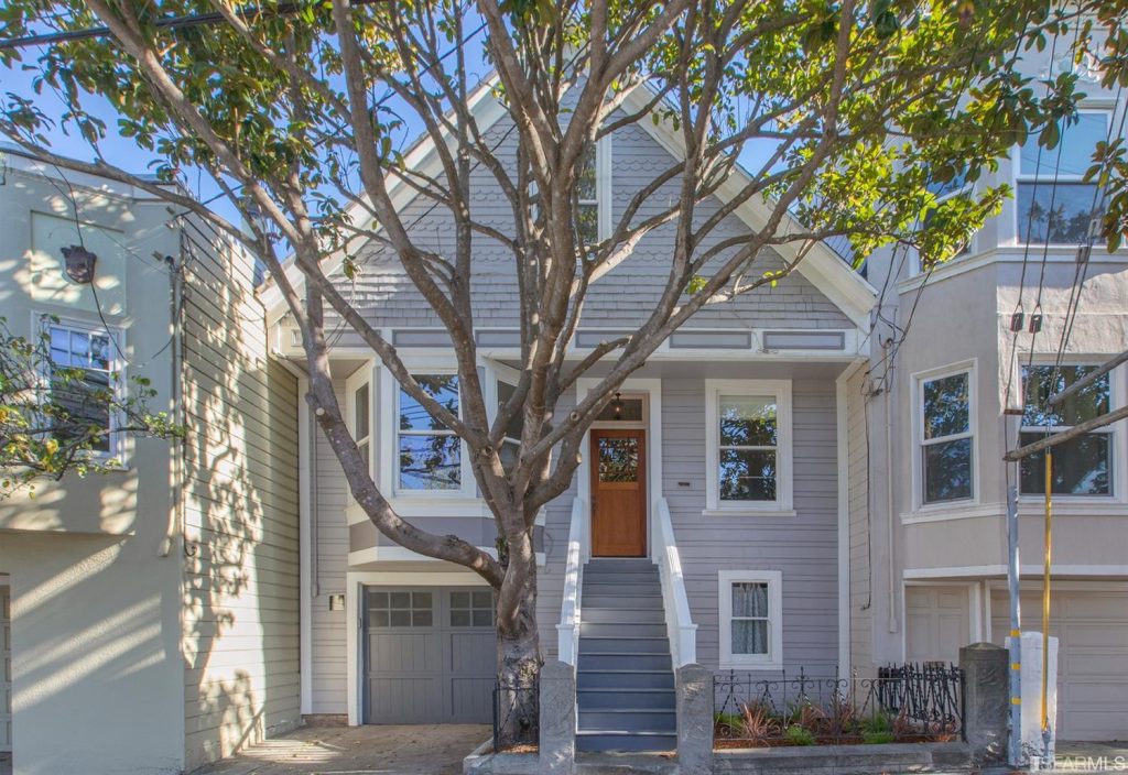 Front exterior view of 207 Chenery, showing a home with light grey facade