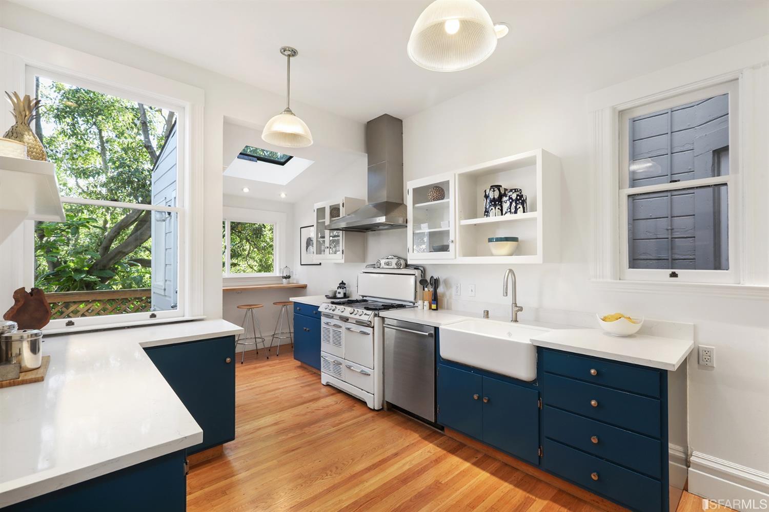 Kitchen, featuring wood floors and large windows