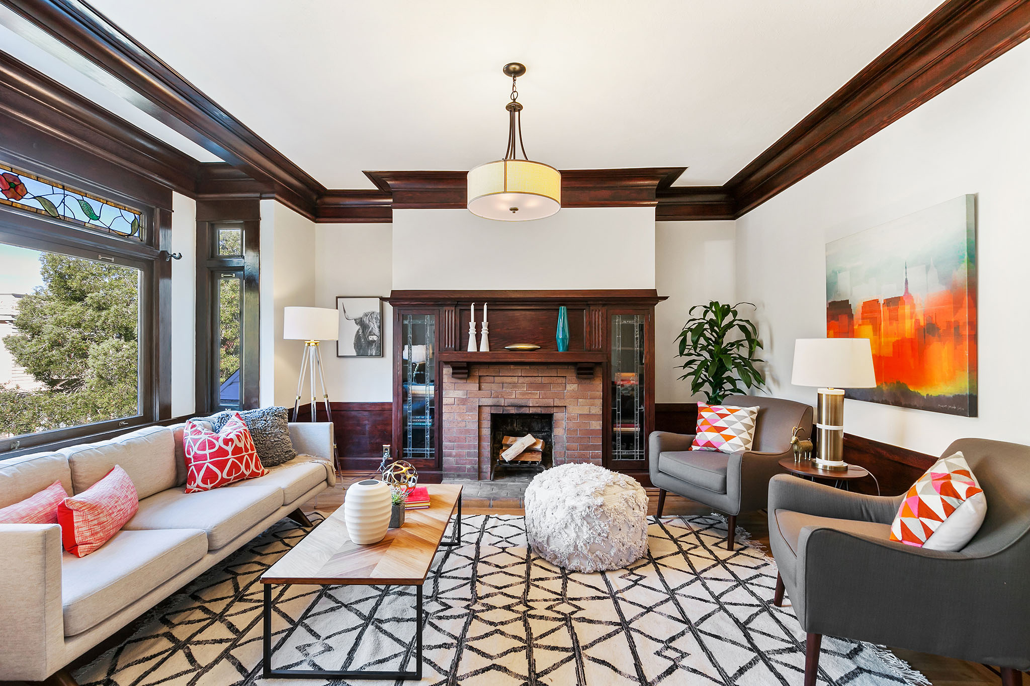 Living room with wood crown moulding and a fireplace