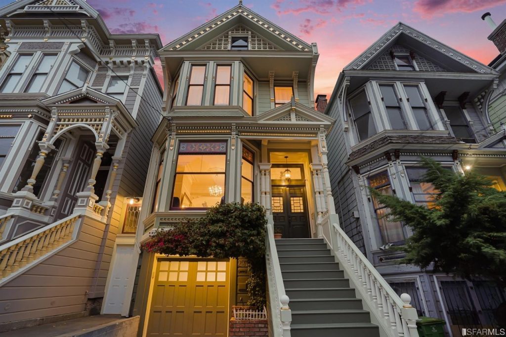 Front exterior view of 277 Central Ave, showing a beautiful Victorian home with pale green facade