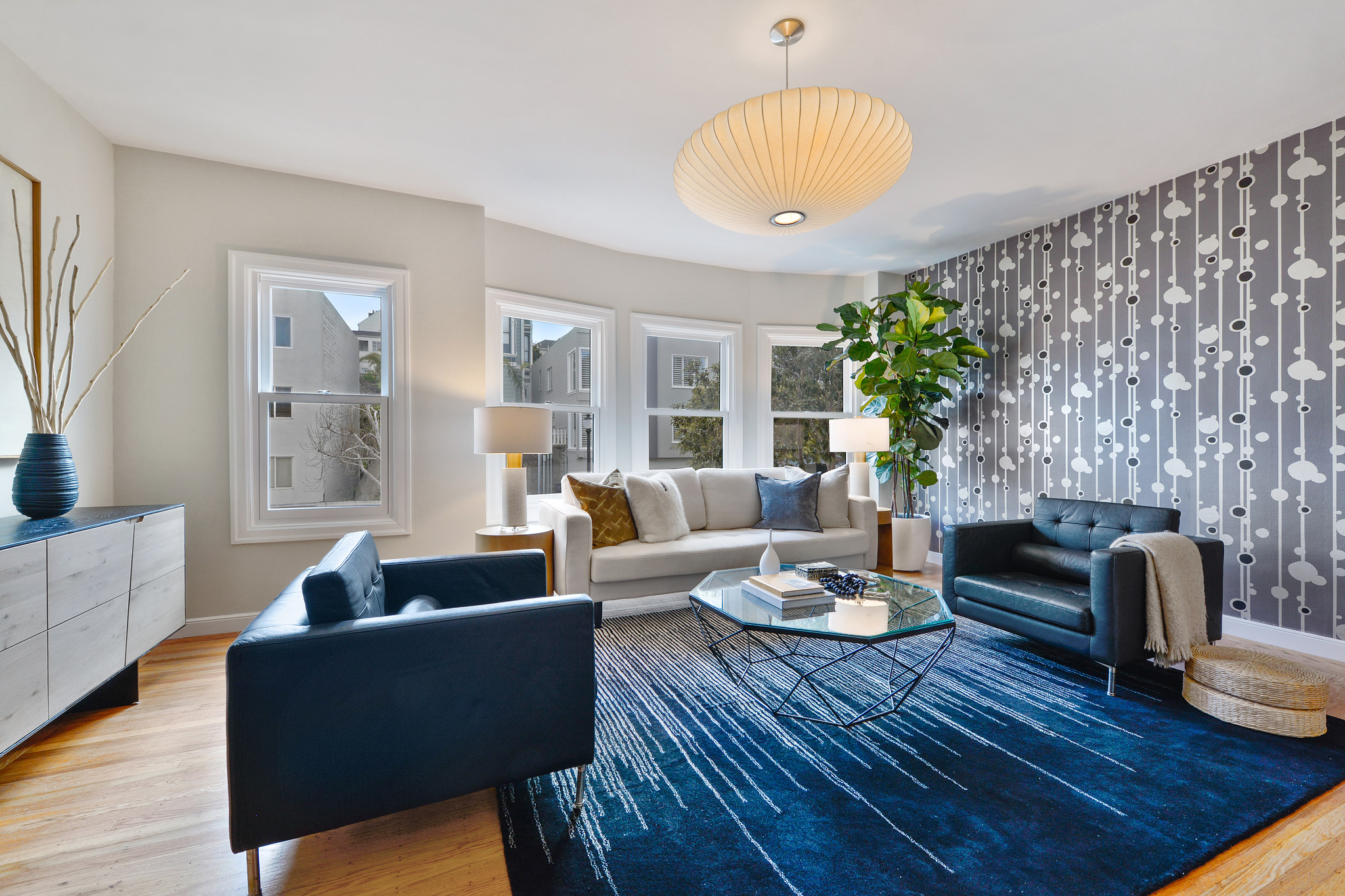 Living room showing an art deco wall paper and light fixture