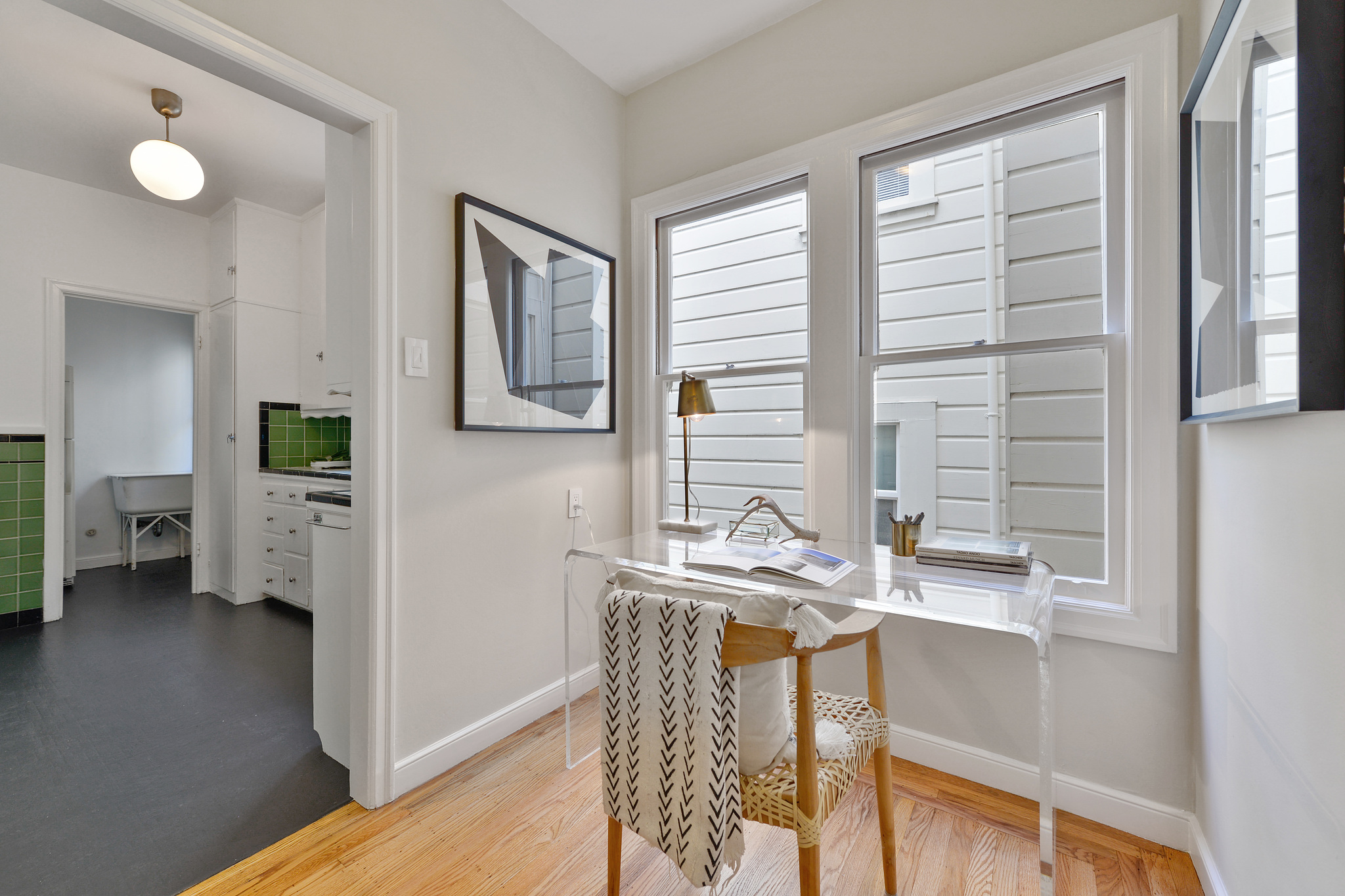 Office area situated beneath two large windows