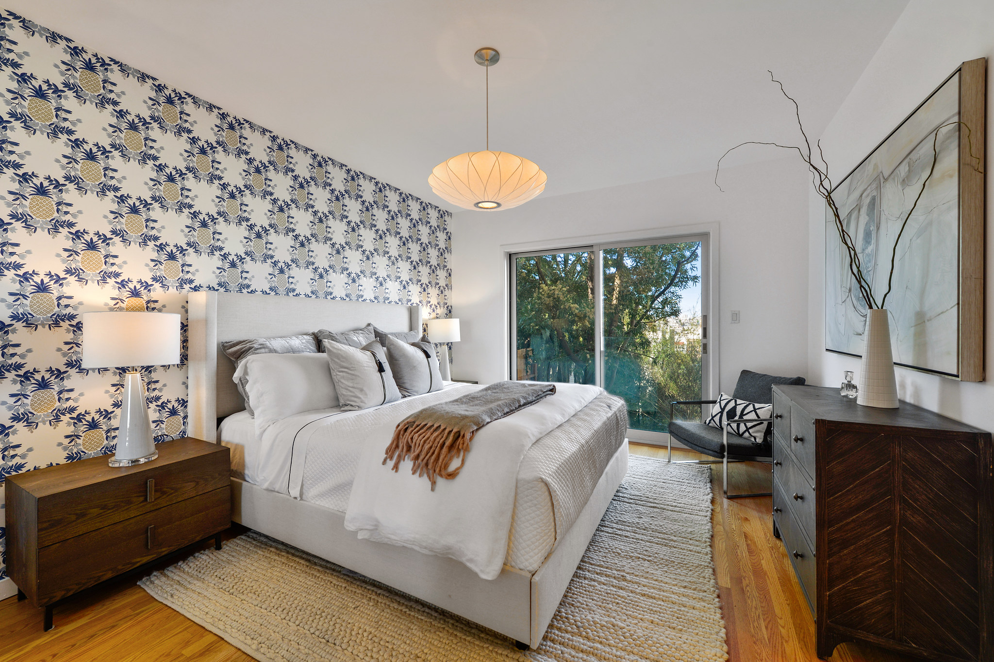 A third large bedroom with glass doors leading out