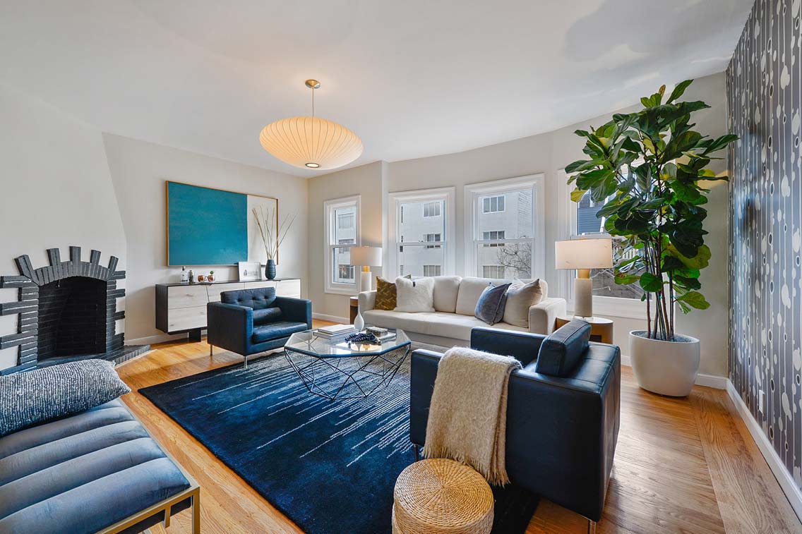 The crisp white art deco living room of 228 Liberty