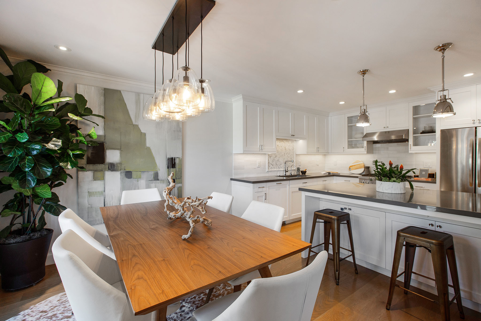 On the dining room side of the kitchen island there are two stools for seating.