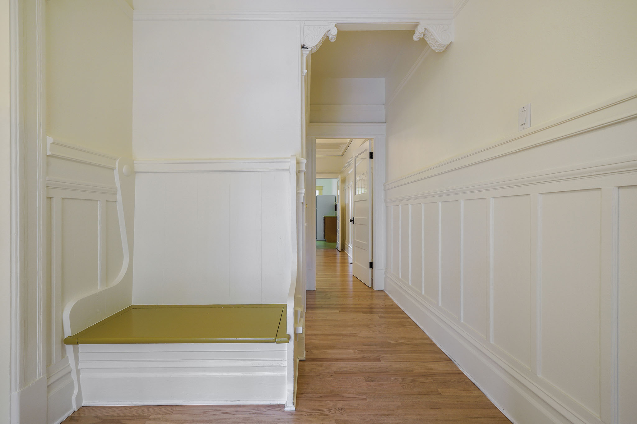 Hallway with wood floors and beautiful wainscoting