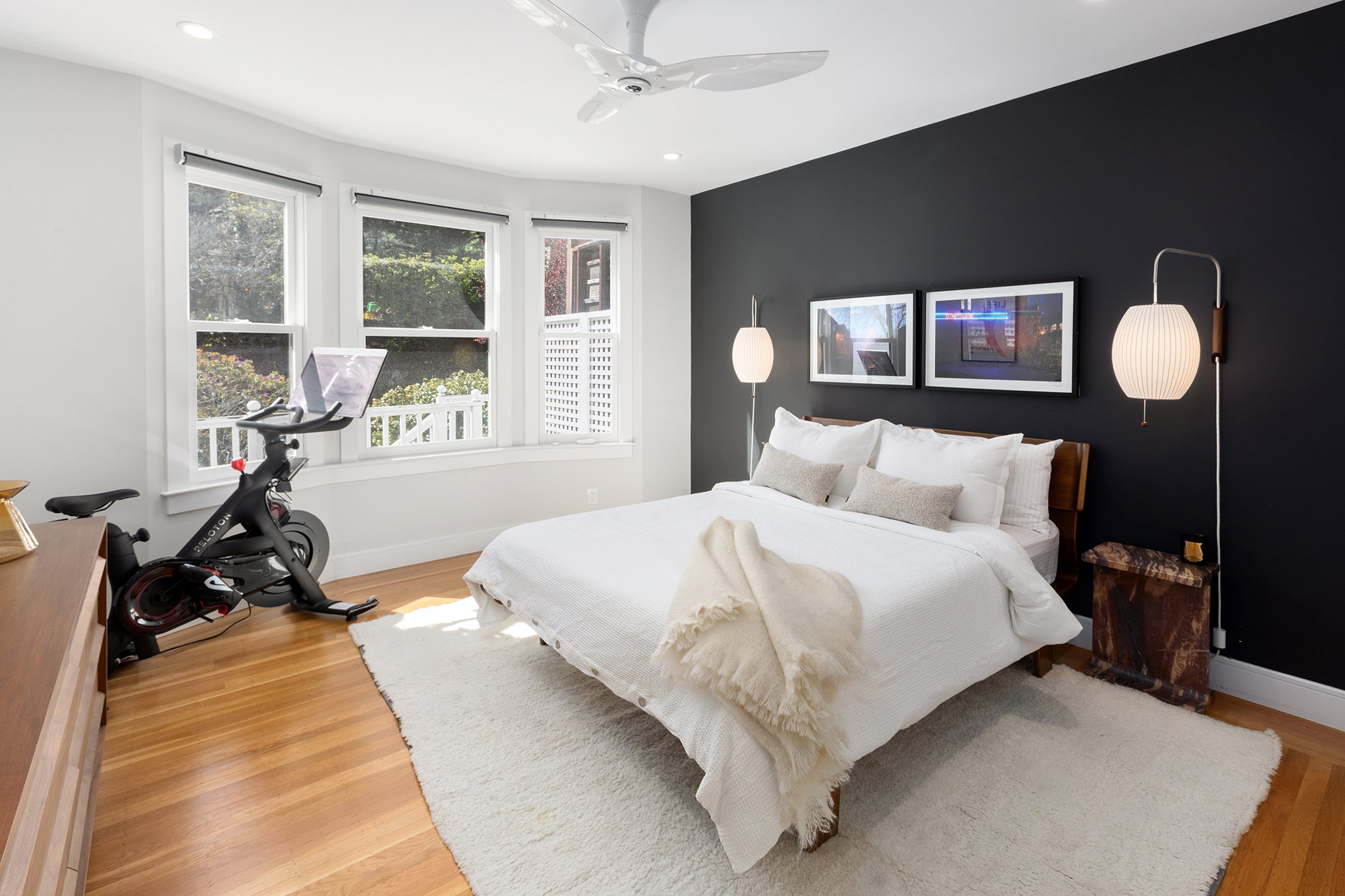 Second bedroom with bay windows and wood floors