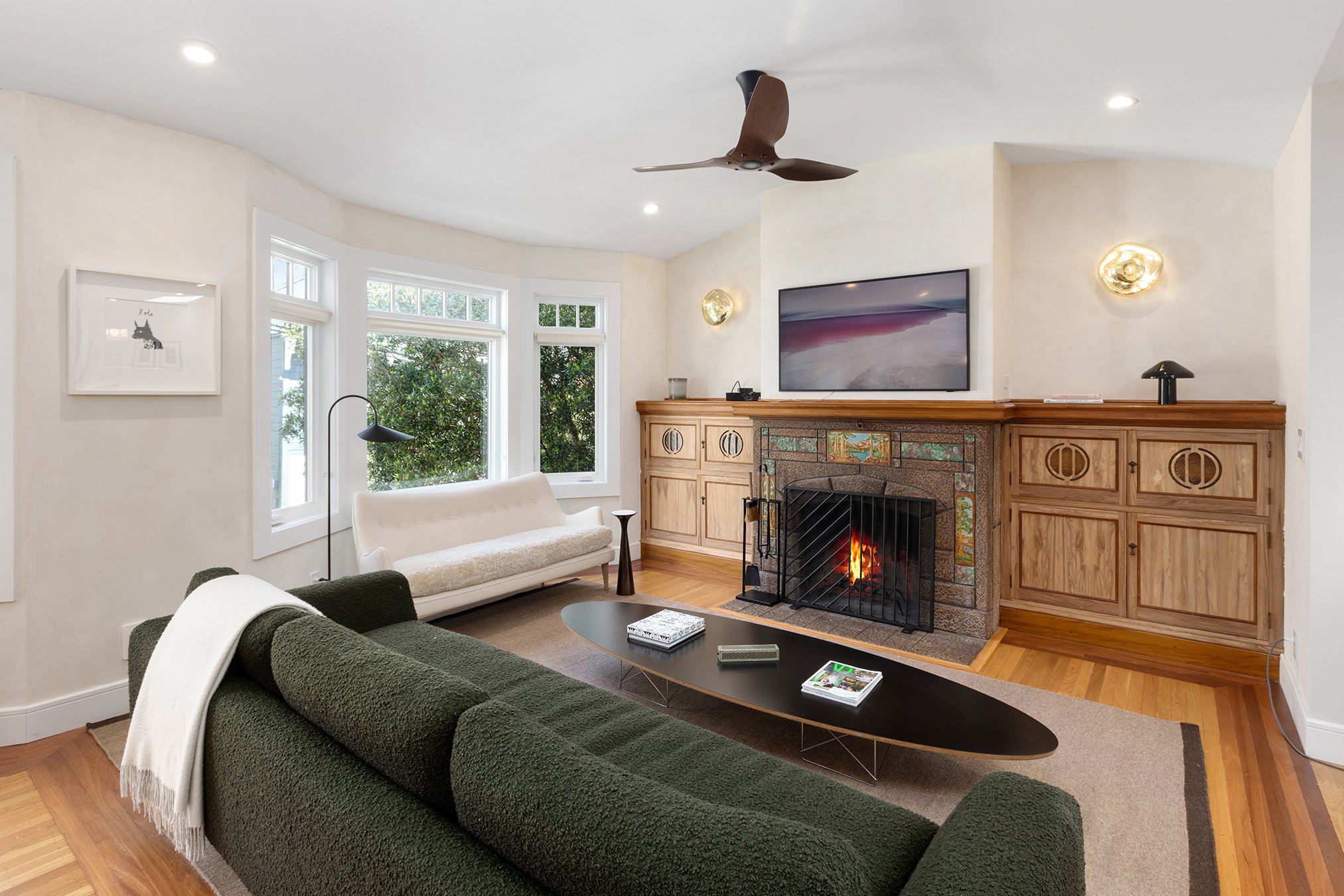 Living room with a fireplace and wood floors