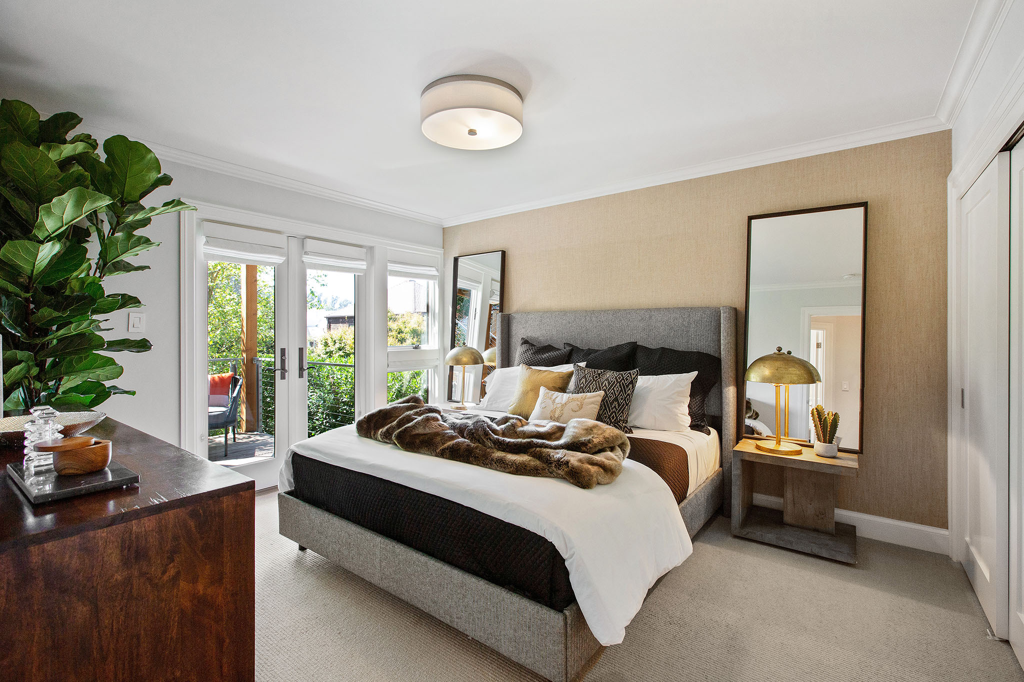 View of a bedroom with large French doors leading outside