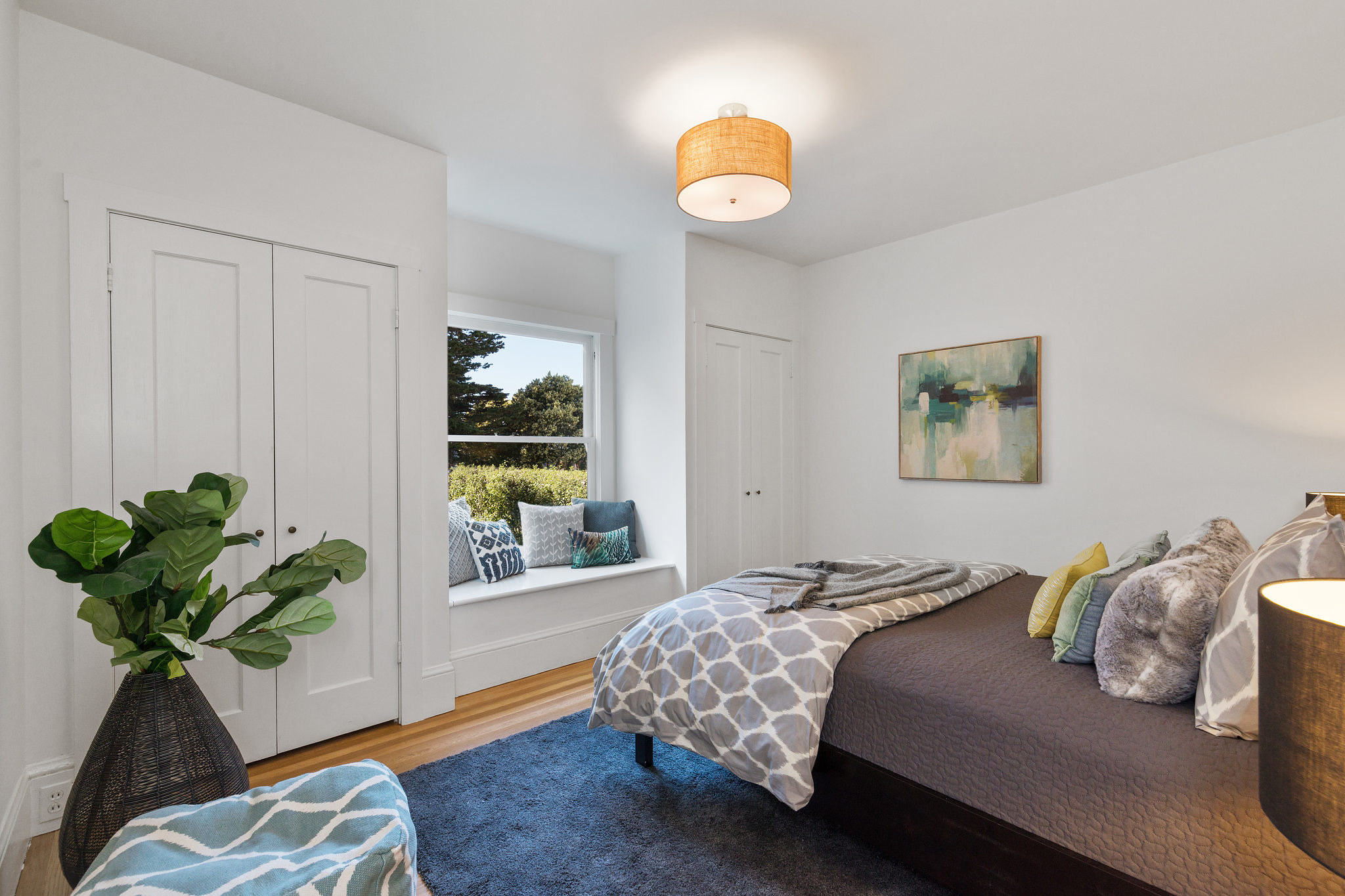View of the bedroom with built-in closets and window seat