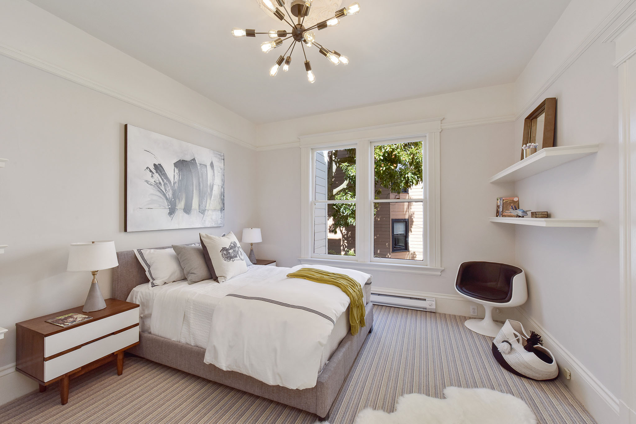 View of a bedroom, featuring large windows and carpeting