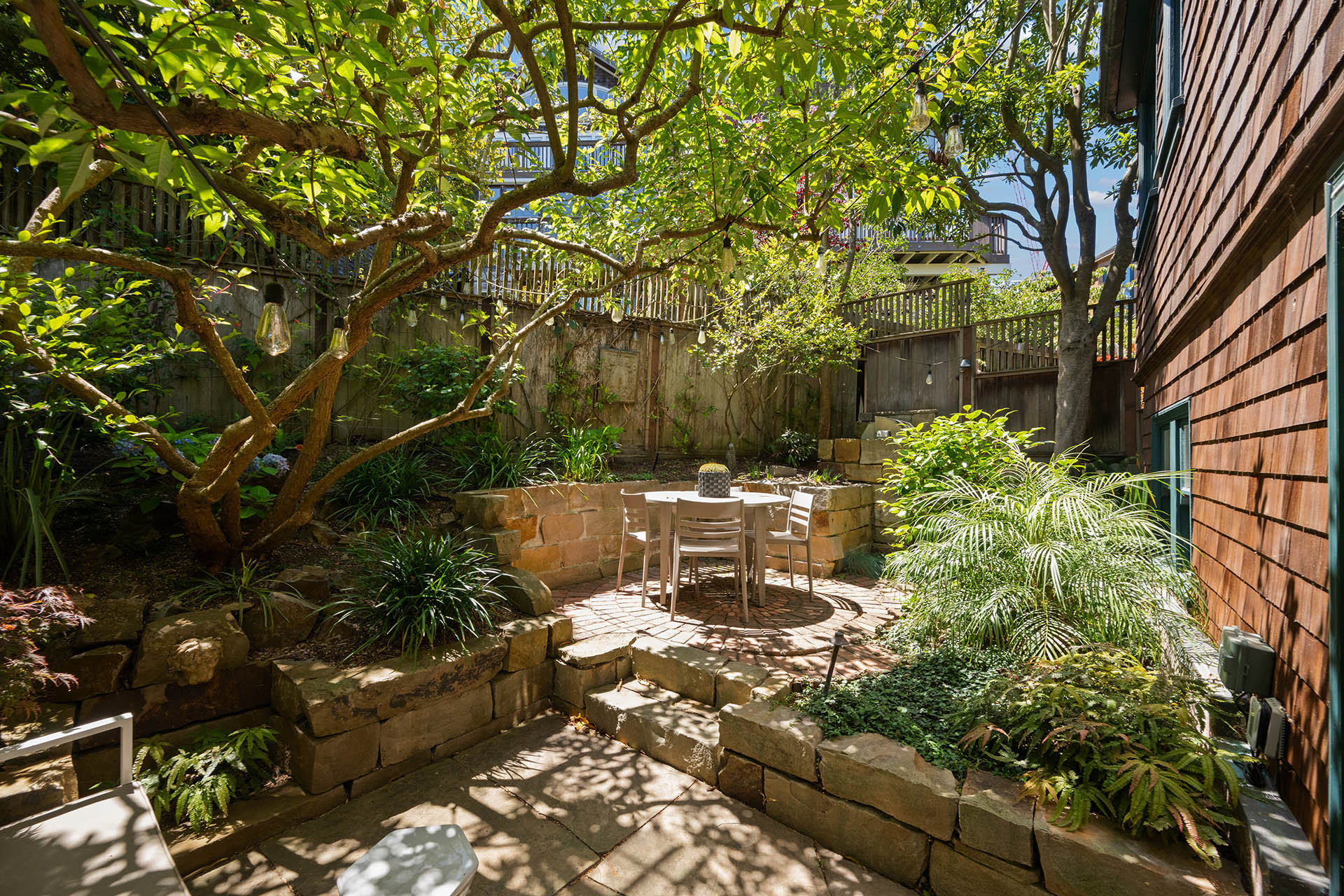 The yard is right off the dining room. Lots of lush greenery.