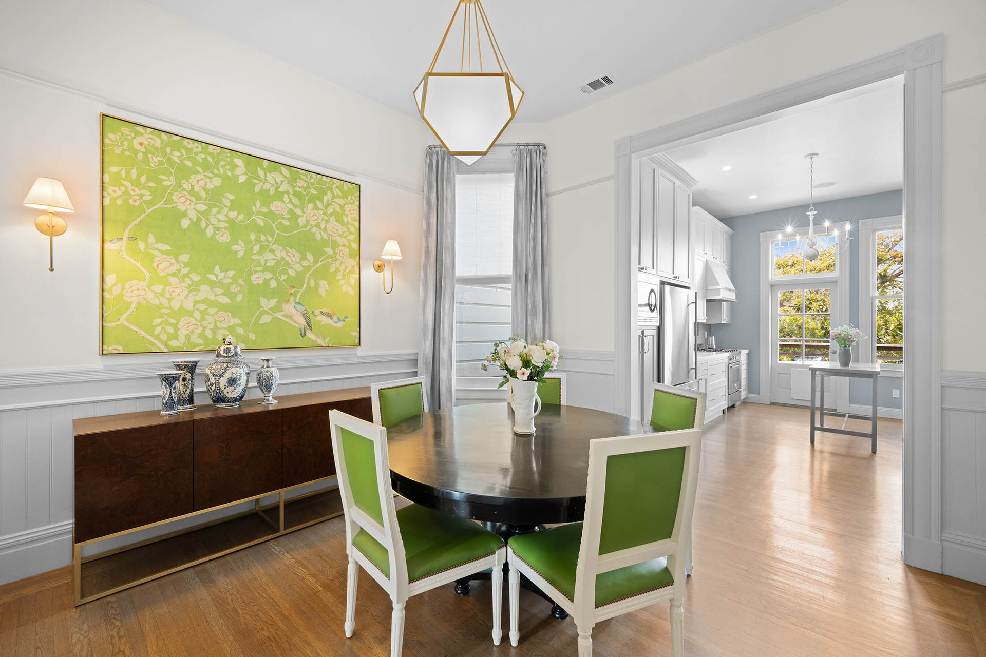 Dining room has round table with 5 chairs and opens up to the kitchen.