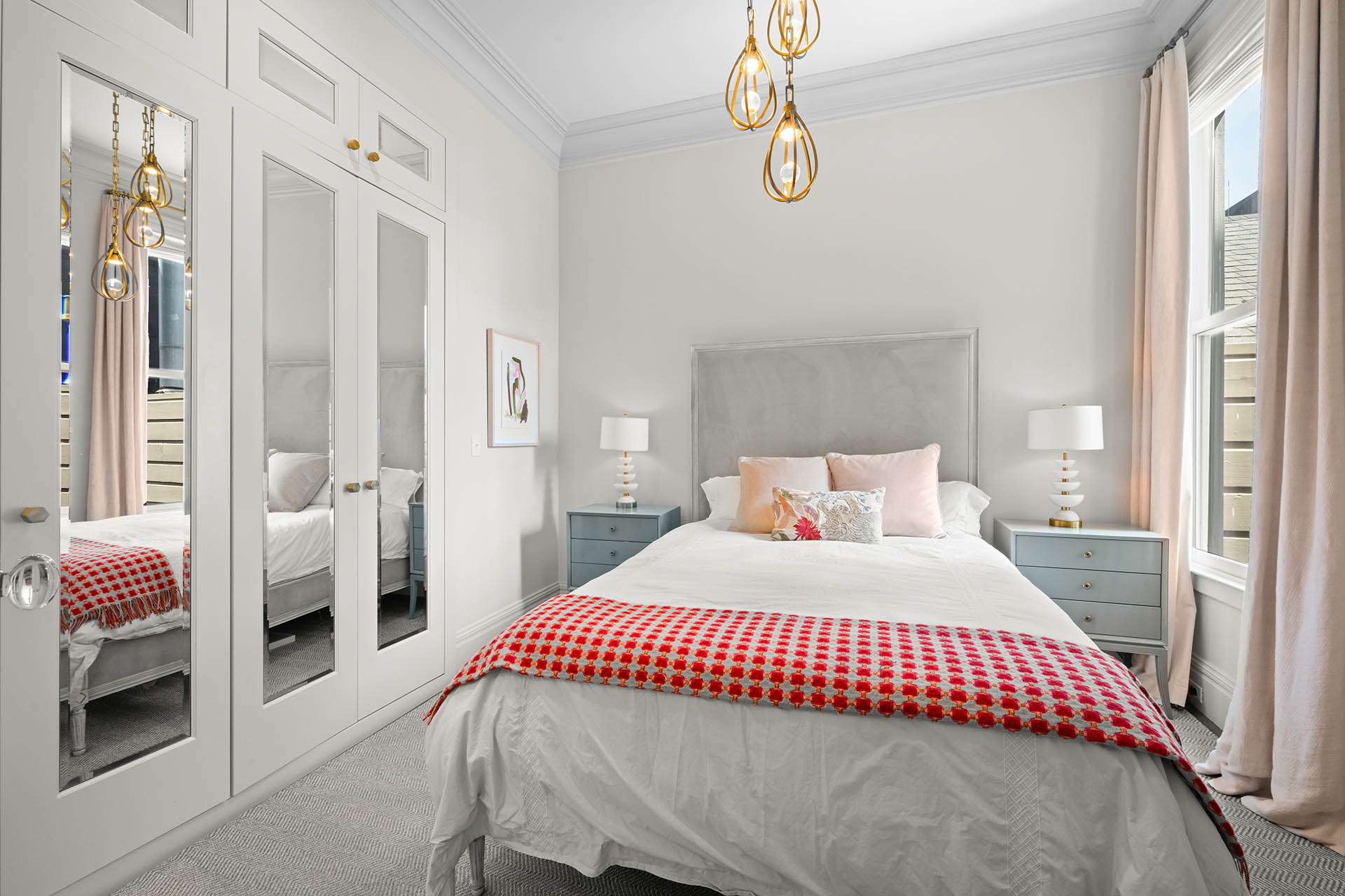 Primary bedroom has queen bed with nightstands on each side. Large built in closet has mirrored doors.