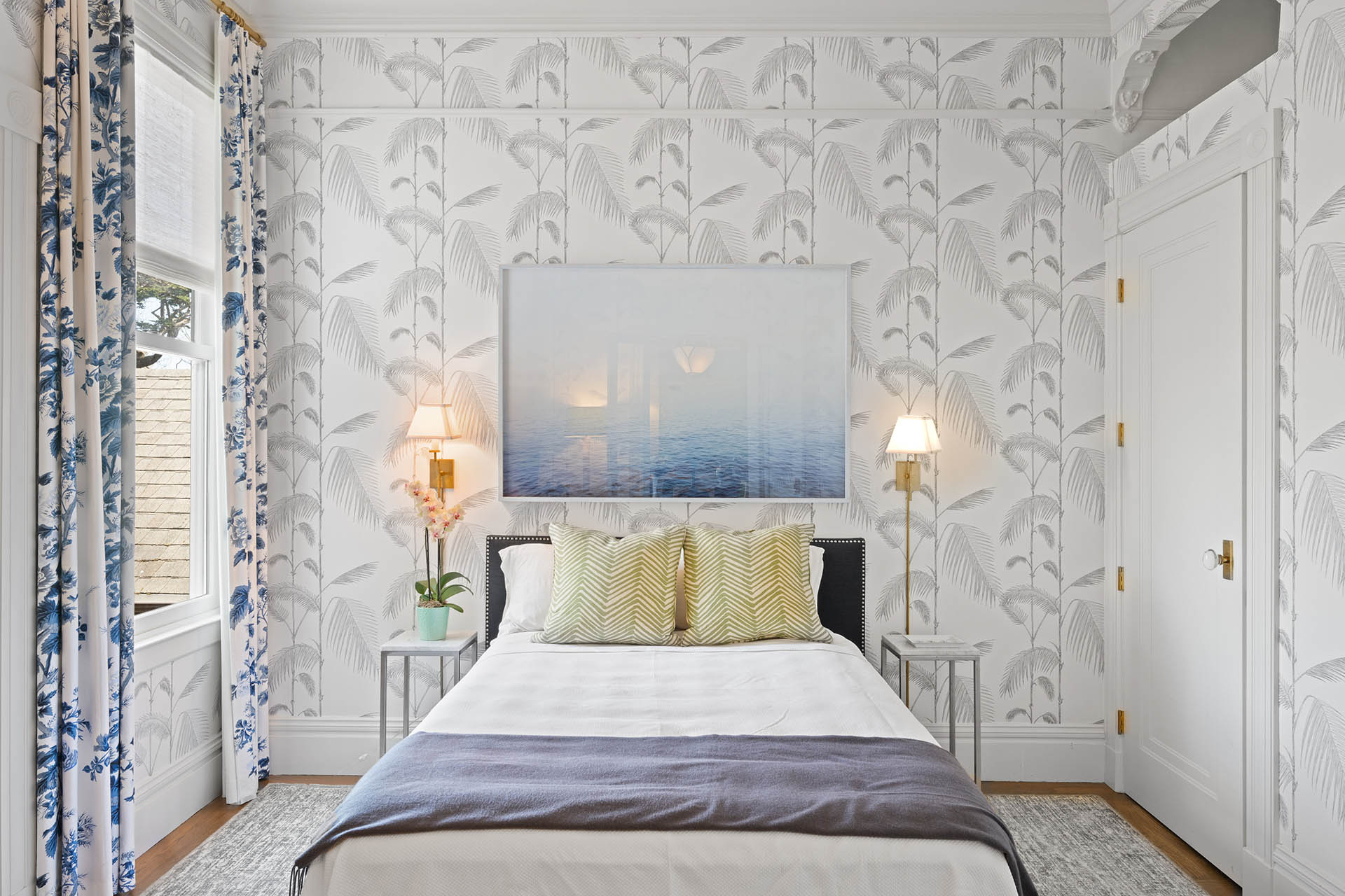 Guest room has beautiful wallpaper and hardwood floors throughout