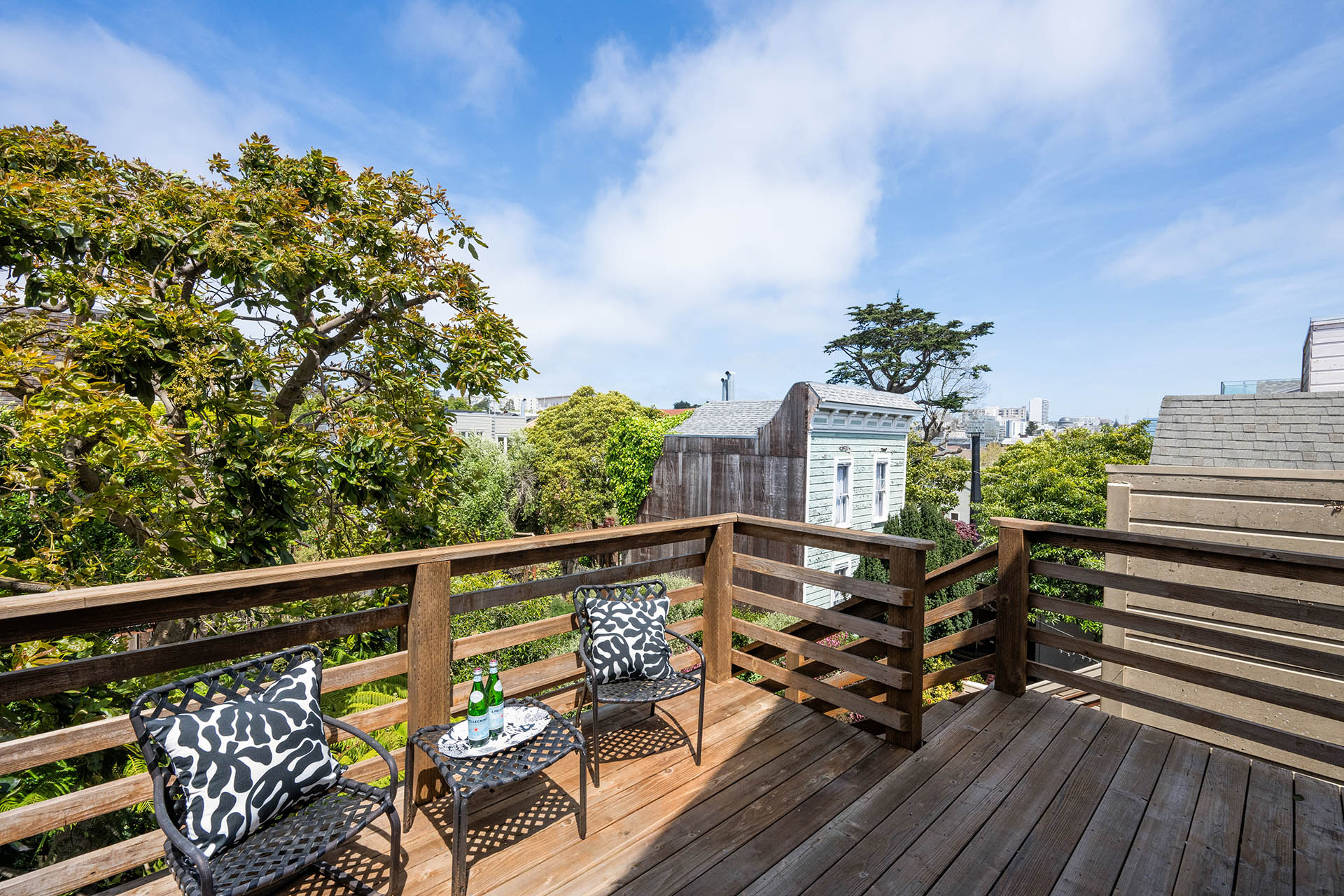 The deck off the kitchen has lots of greenery and you can see downtown SF in the distance.