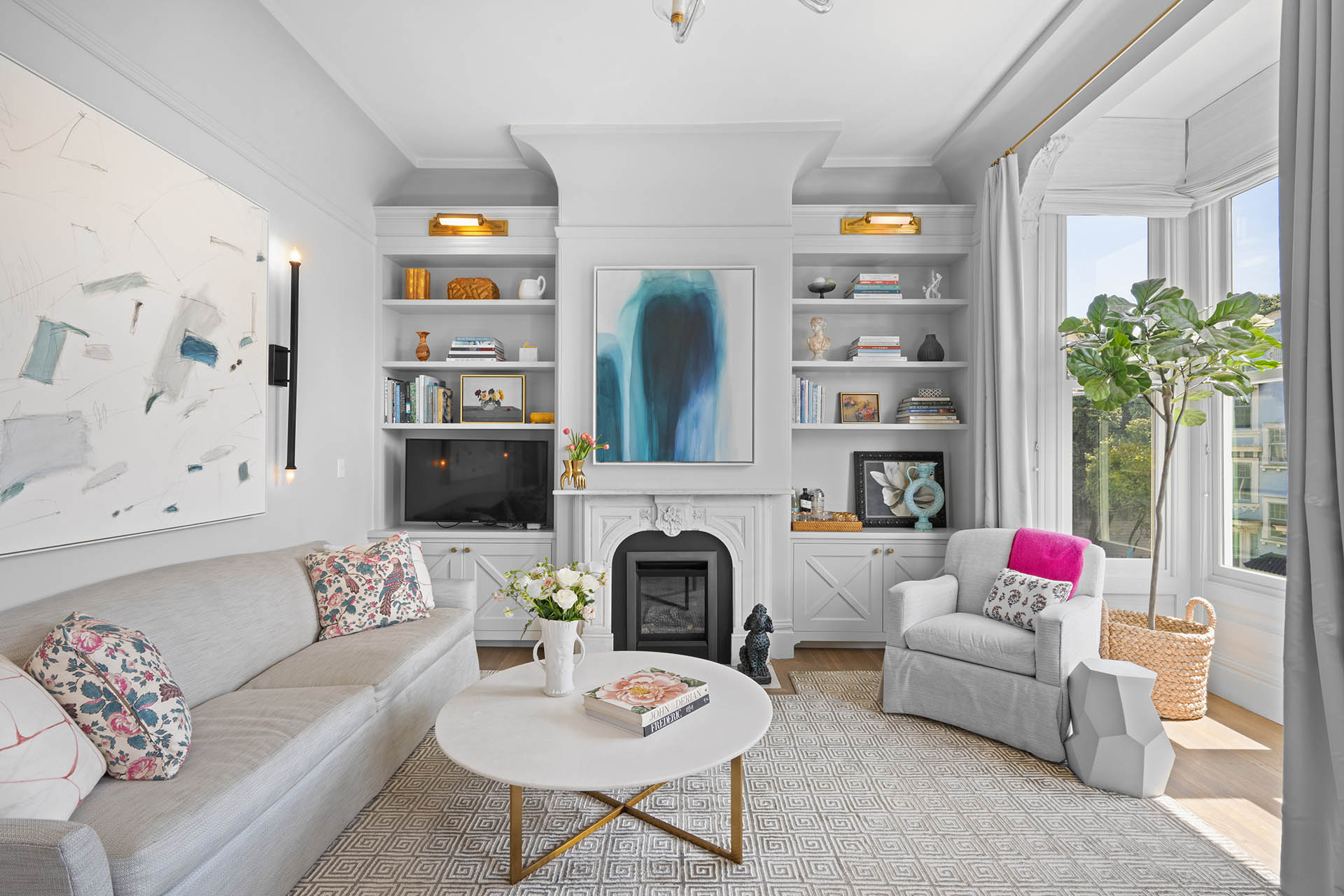 Living room has beautiful fireplace with built-ins on each side.