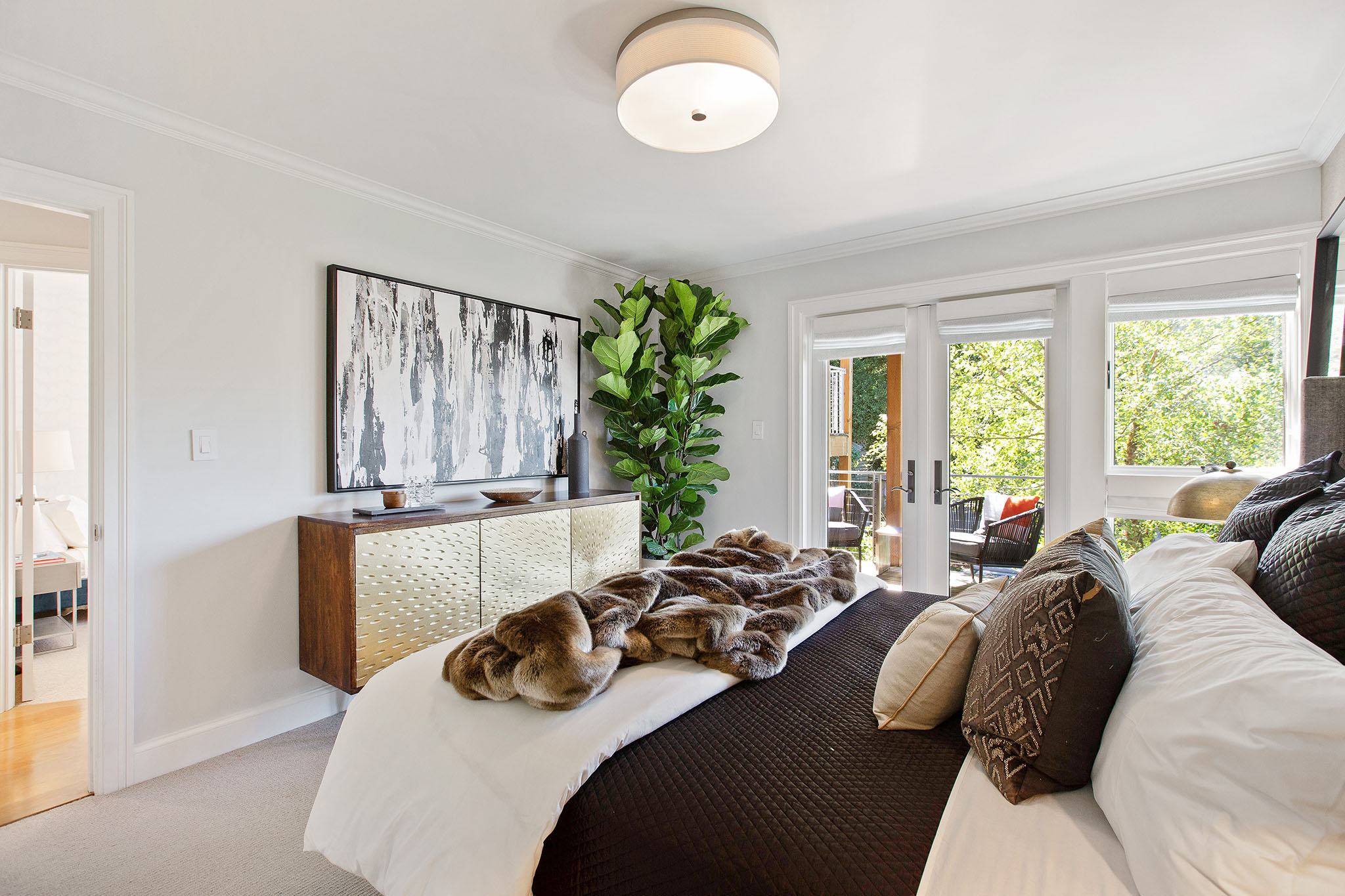 There primary bedroom floor is a light grey carpet and also has room for dresser.