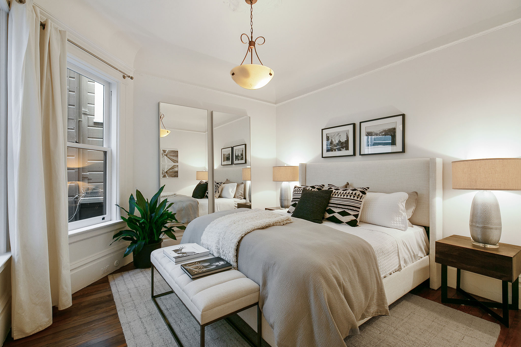 32 View of another bed featuring wood floors and large windows