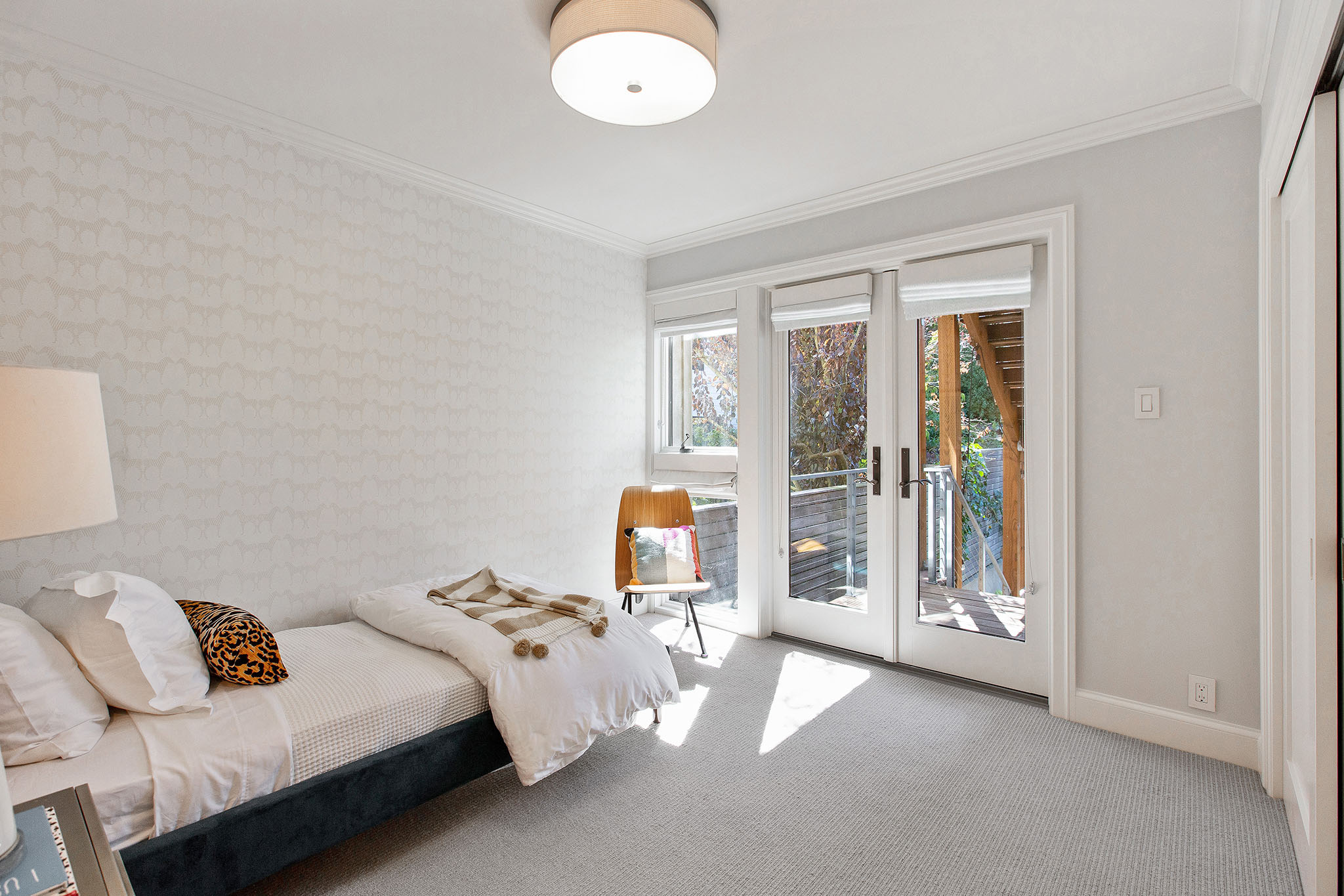 Second bedroom is staged as child's room. There is a also french doors that open up to back yard.