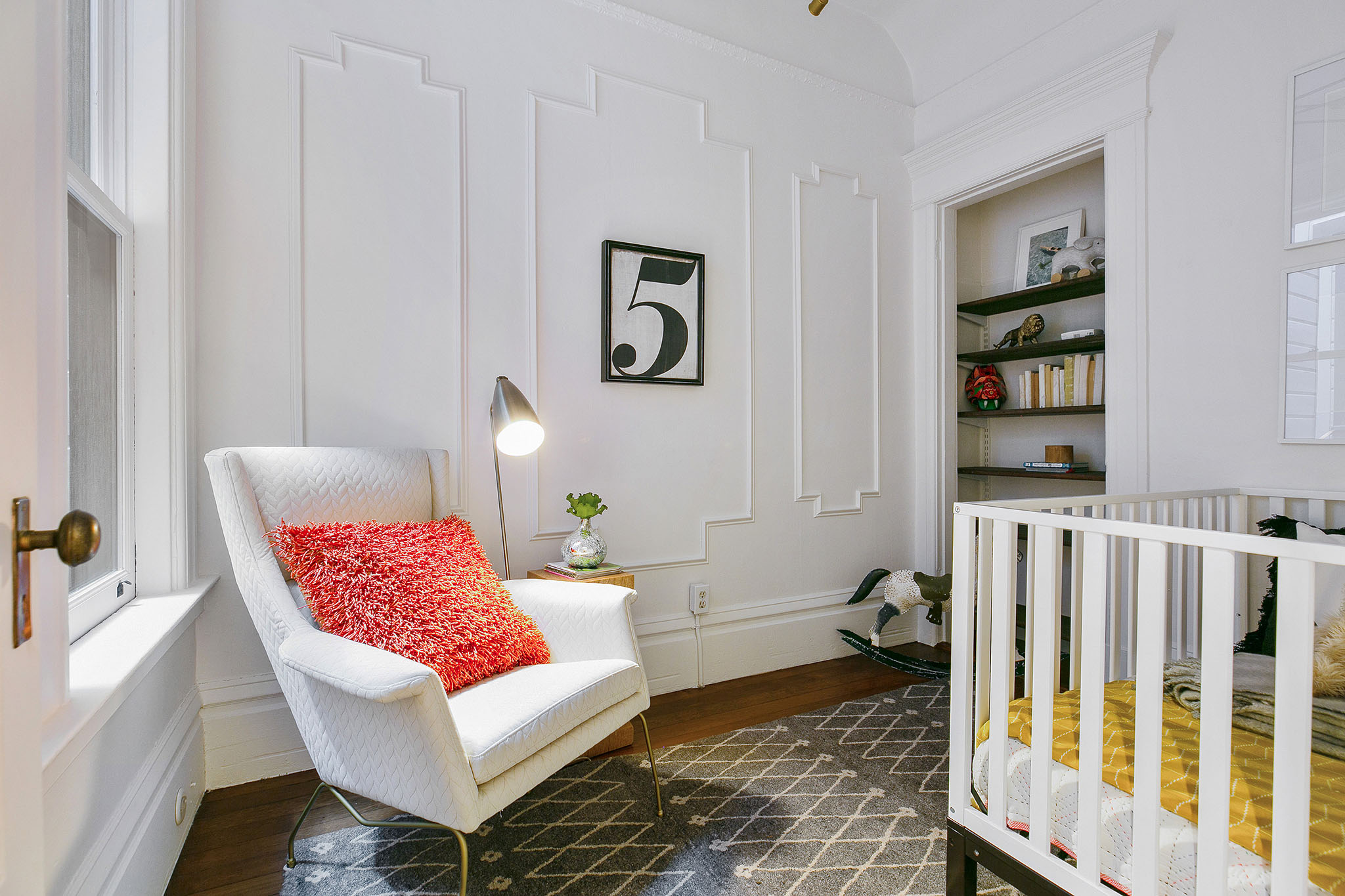 35 View of a third room with white wainscoting, a large window, and a built-in shelf