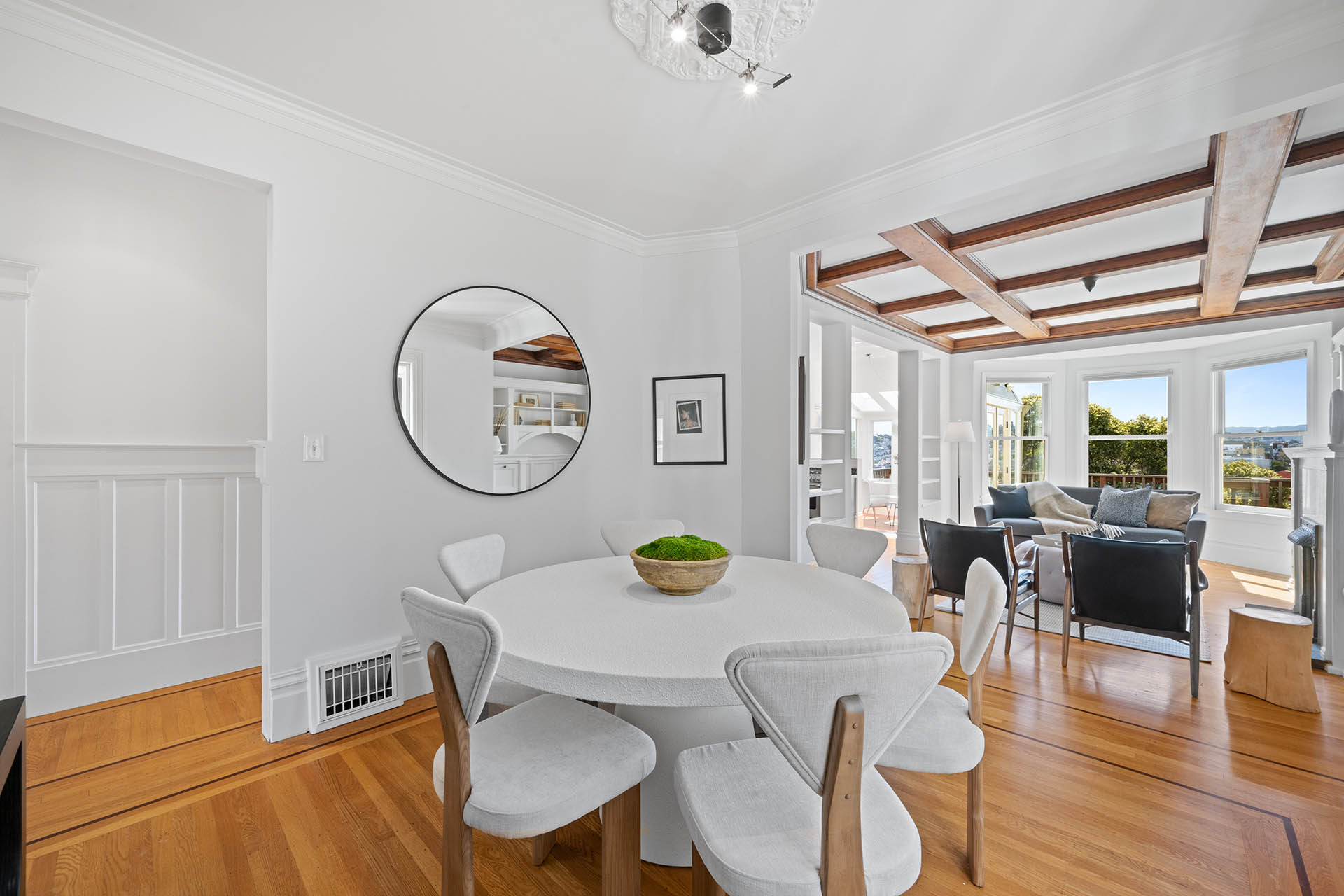 Dining room has large round table with 6 chairs. Opens up to living room.
